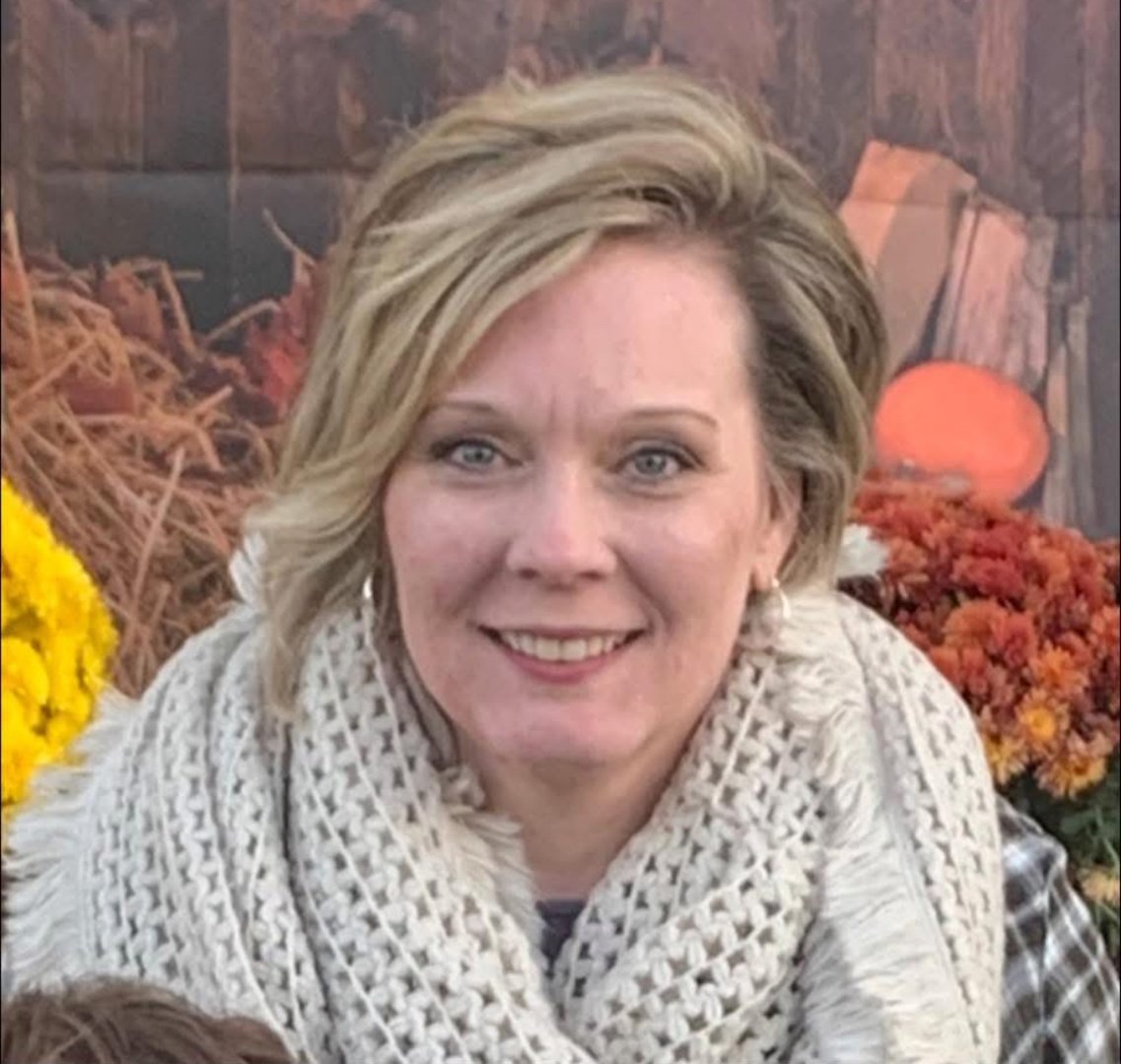 Woman with blonde hair smiling at camera