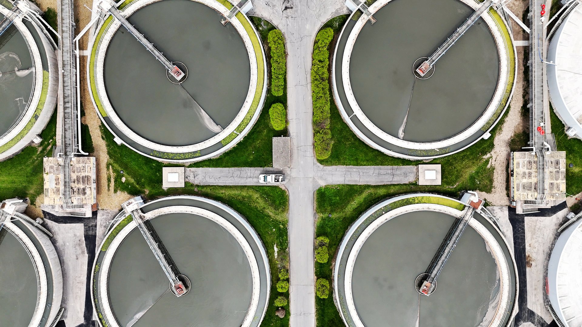 Rising over the intersection of pavement and components of equipment used in the process of treating sewage