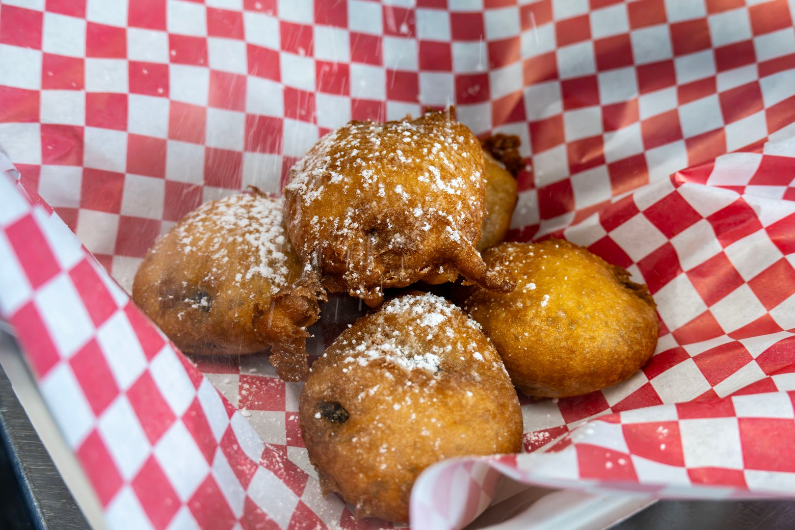 A plate of deep fried Oreos finished off with powdered sugar