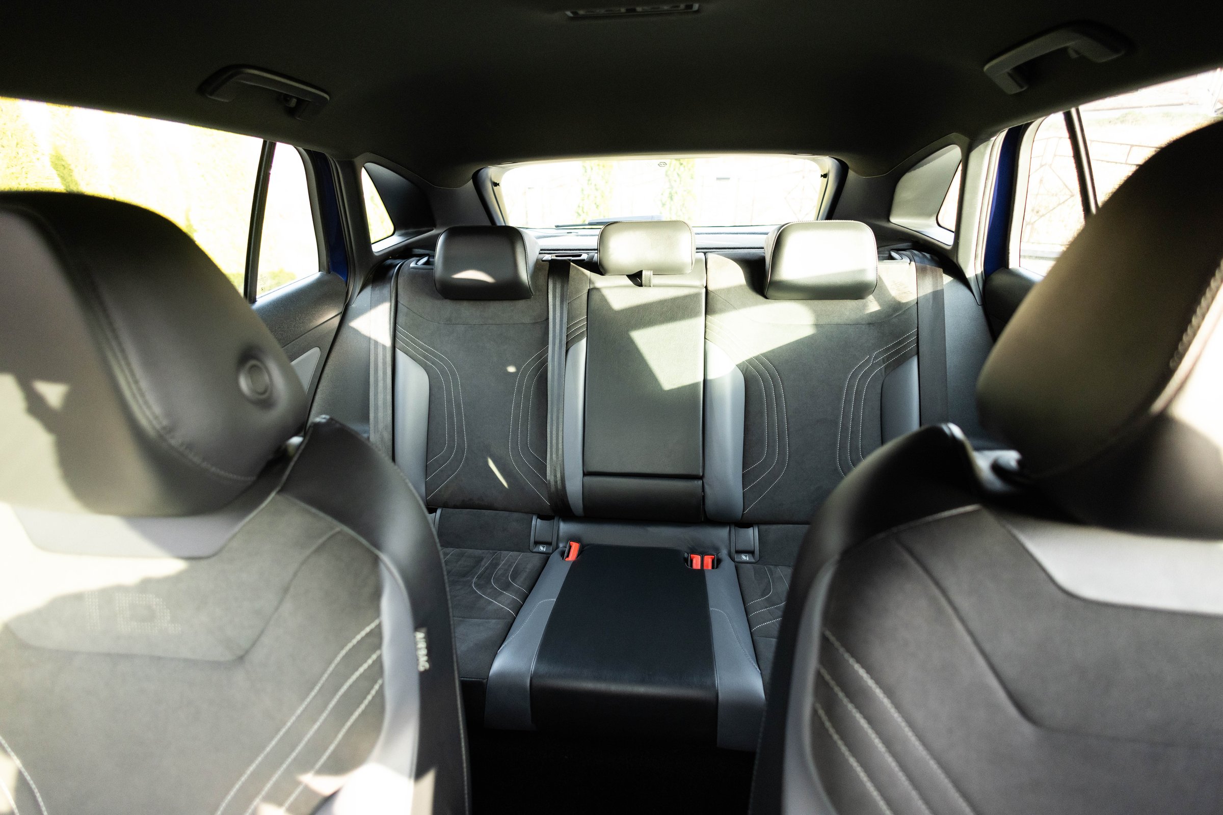 Luxury car rear leather seats row. Interior of new modern clean expensive car. Passenger seats with leather. Closeup details. New electric car inside. Car cleaning theme.