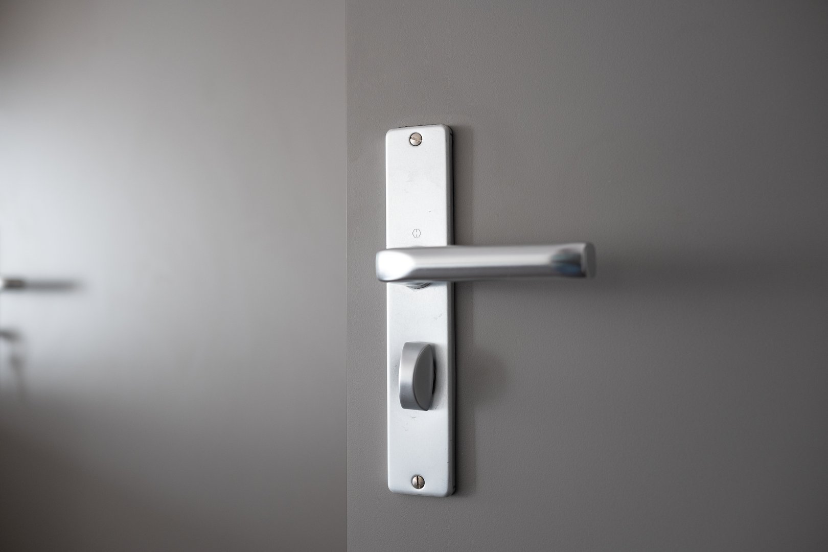 Grey wooden apartment door and modern metal lock