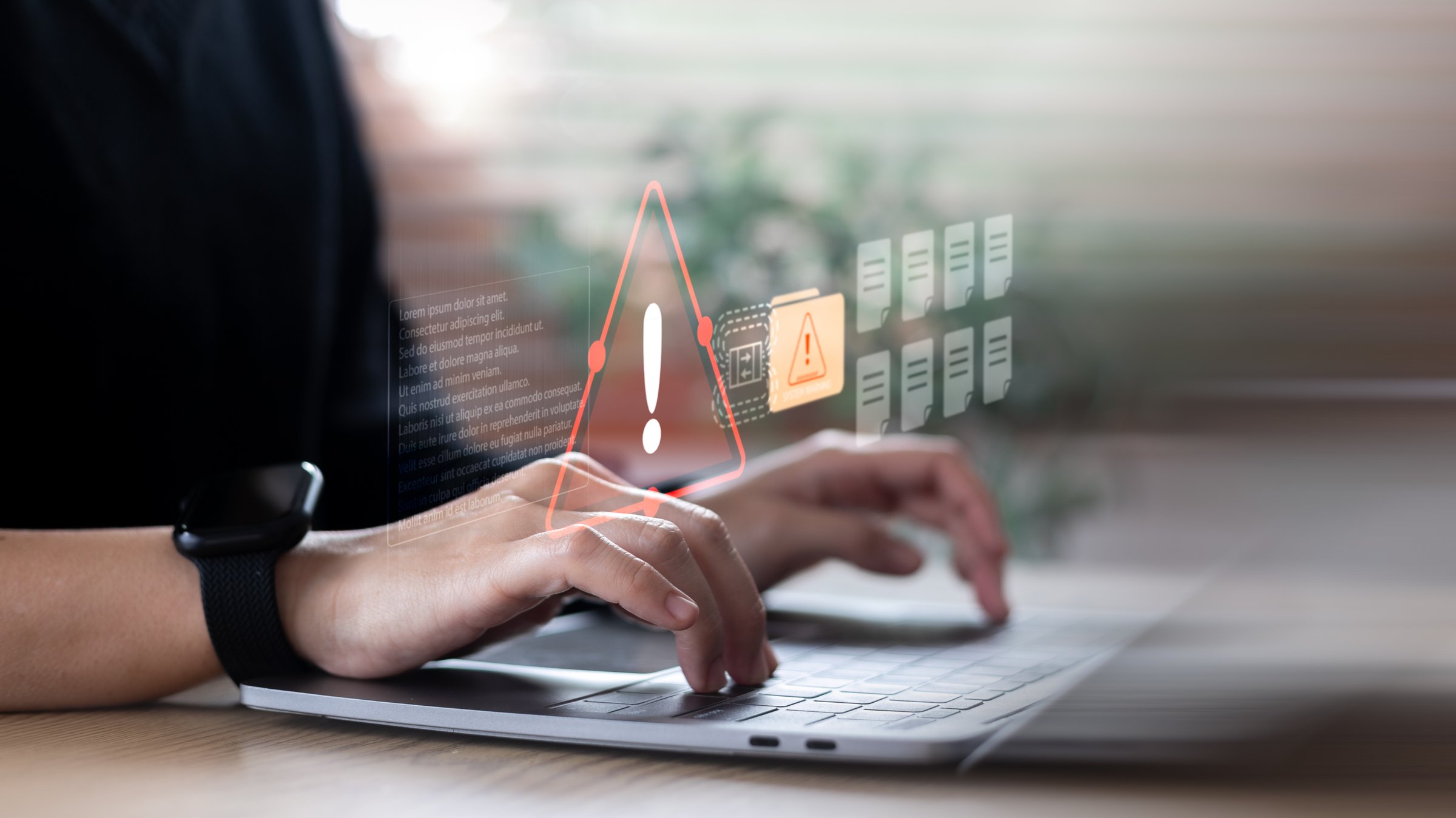 An alert warning symbol on the computer screen indicates a system error or cybersecurity risk. Suitable for data breach, IT security, or malware warning concept.