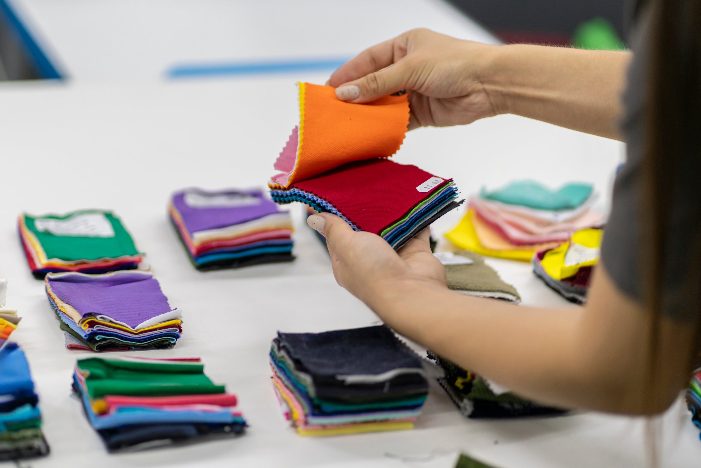 tailor choose fabric color from samples on the table