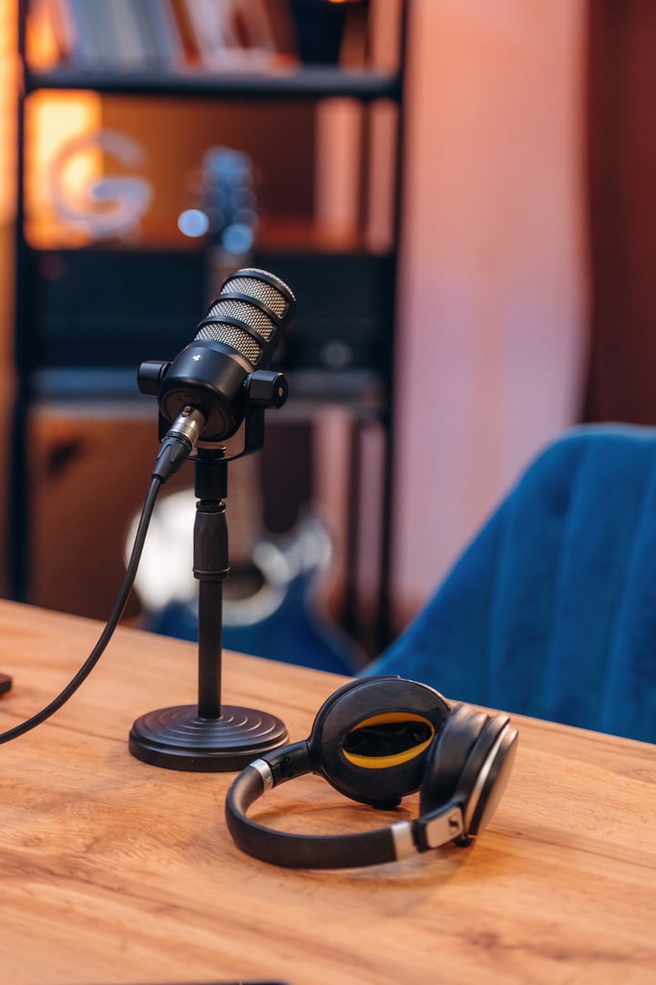Microphone and headphones are on the table, room for podcasts.