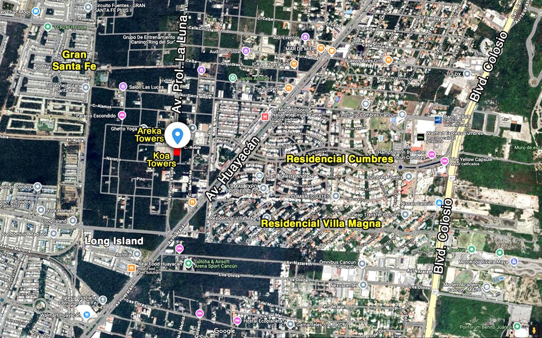 Aerial view of Koa Towers' location in Cancun, Mexico, highlighting nearby residential areas and major roads.