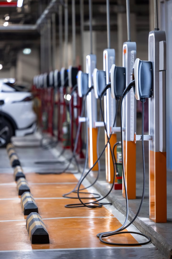 EV charging station and electric car, Electric car charging station for charge EV battery, Plug for vehicle with electric engine, EV charger clean energy, Charging point at car parking lot.