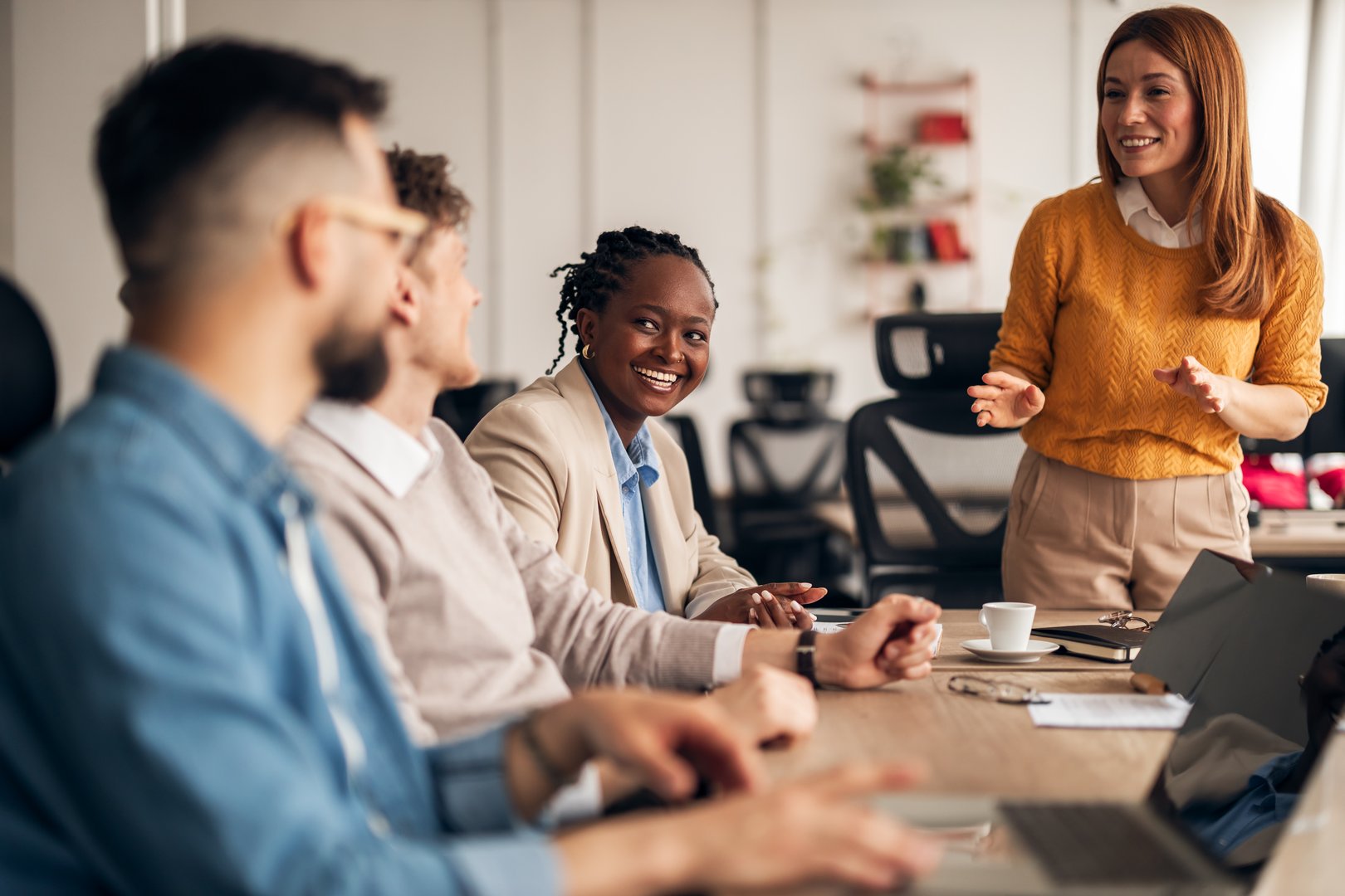 Group of professionals interact and collaborate during a meeting, fostering teamwork and communication in a modern office. A mood of connection and productivity.
