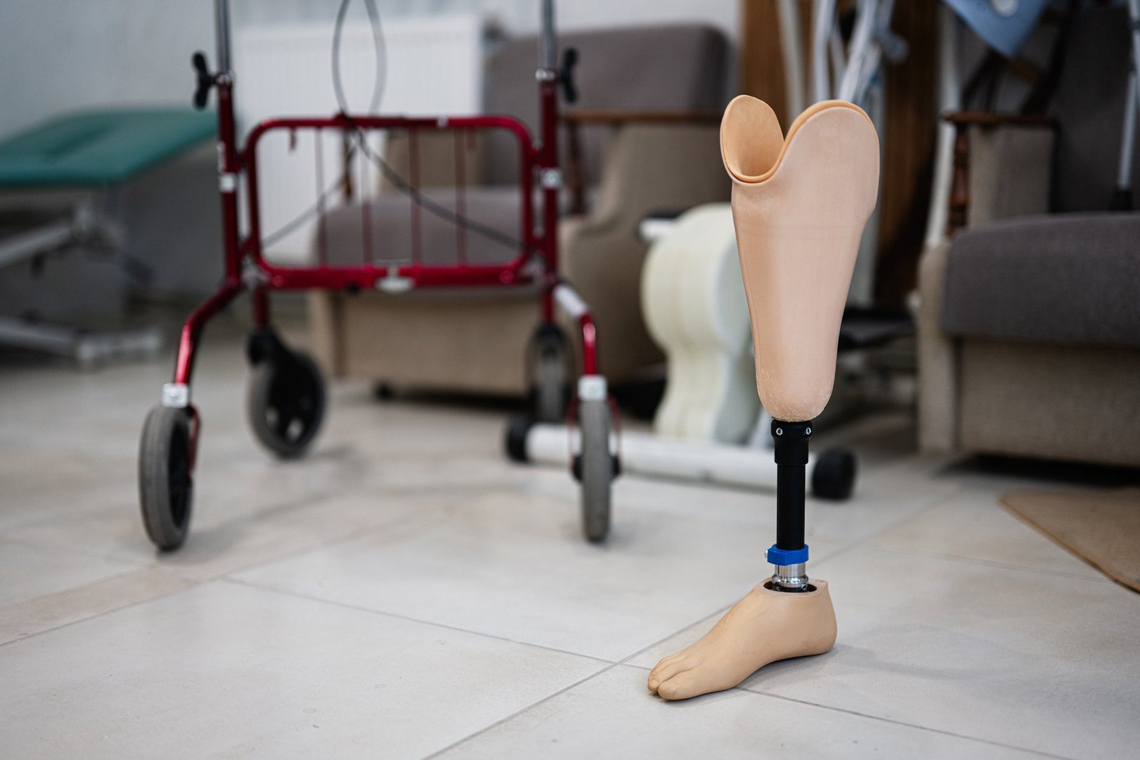 Prosthetic leg standing in a rehabilitation center alongside a walker, symbolizing recovery and mobility support through modern assistive technology in healthcare.