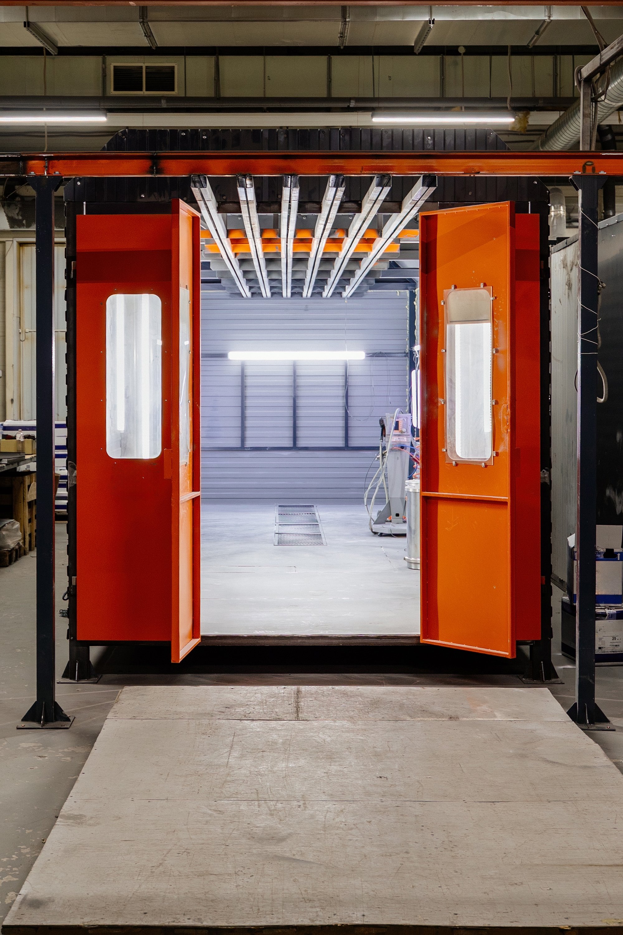 Industrial painting box for painting machine parts in workshop.