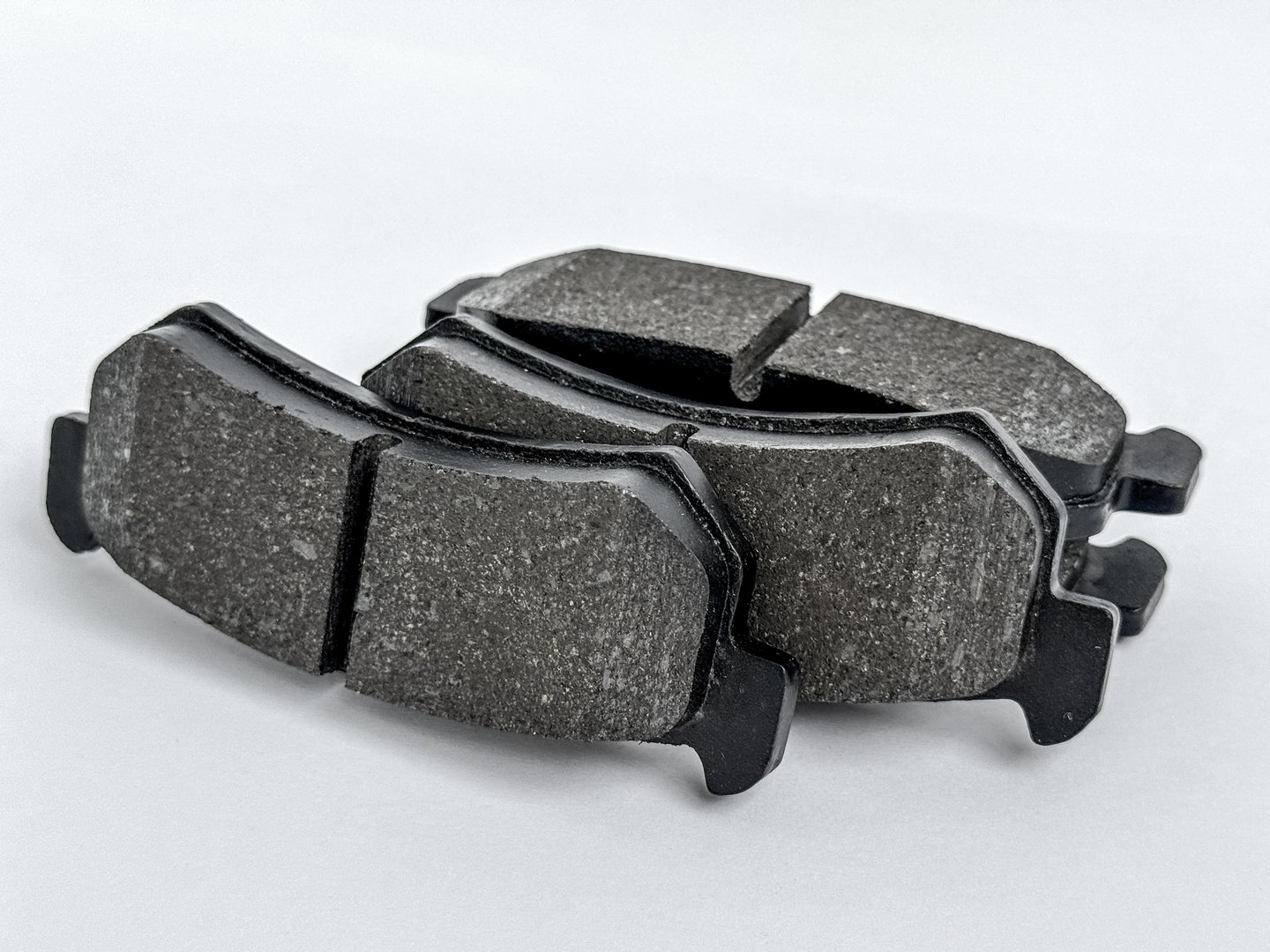 High-quality image of car brake pads, placed on white background. The picture shows details of the texture and material, suitable for automotive catalogues and spare parts presentations.