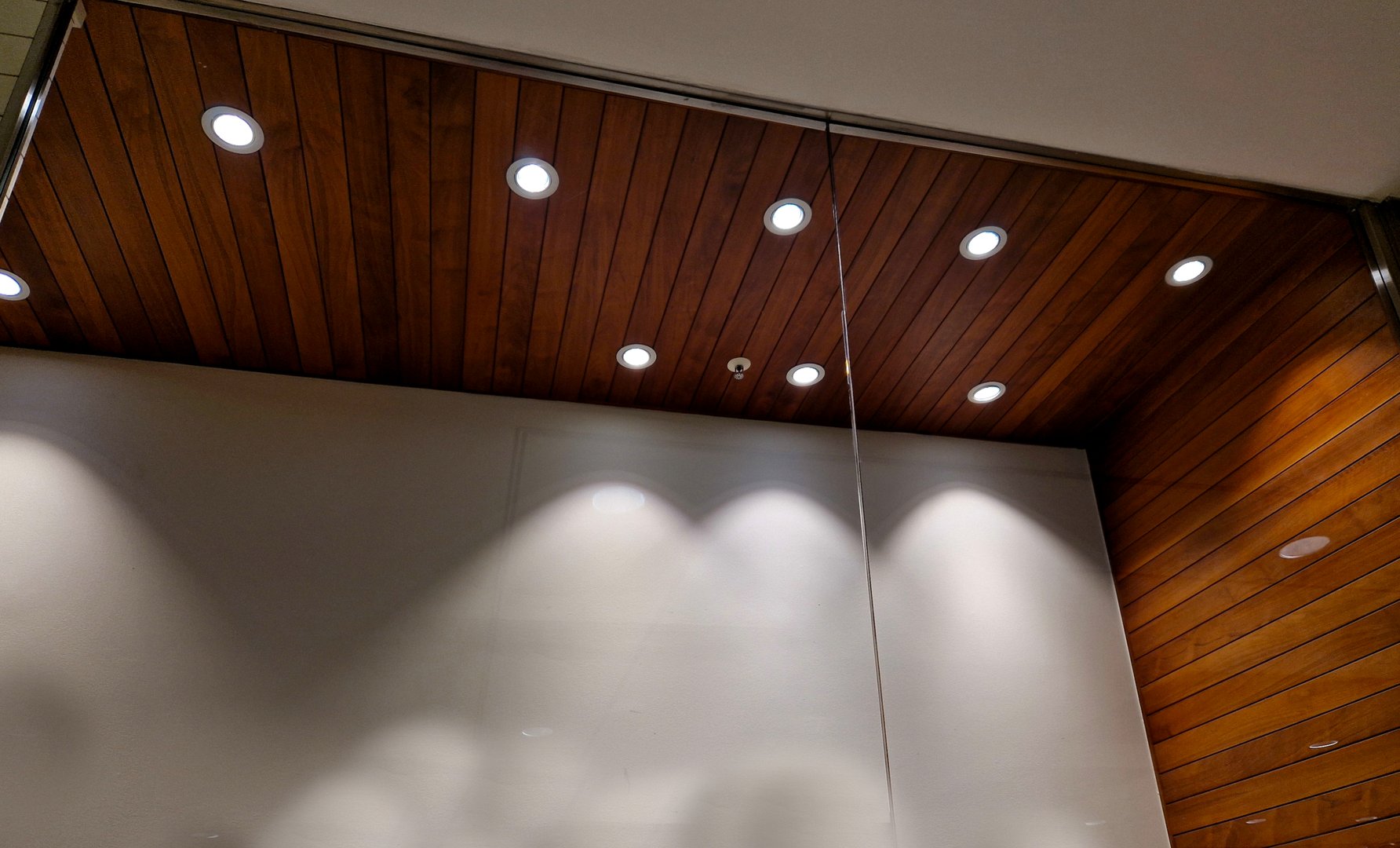 ceiling of the corridor in plasterboard soffit is equipped with light halogens illuminating ramp on the stage or in shop. the goods look better if are strong lamp ceiling, cloakroom, mountain