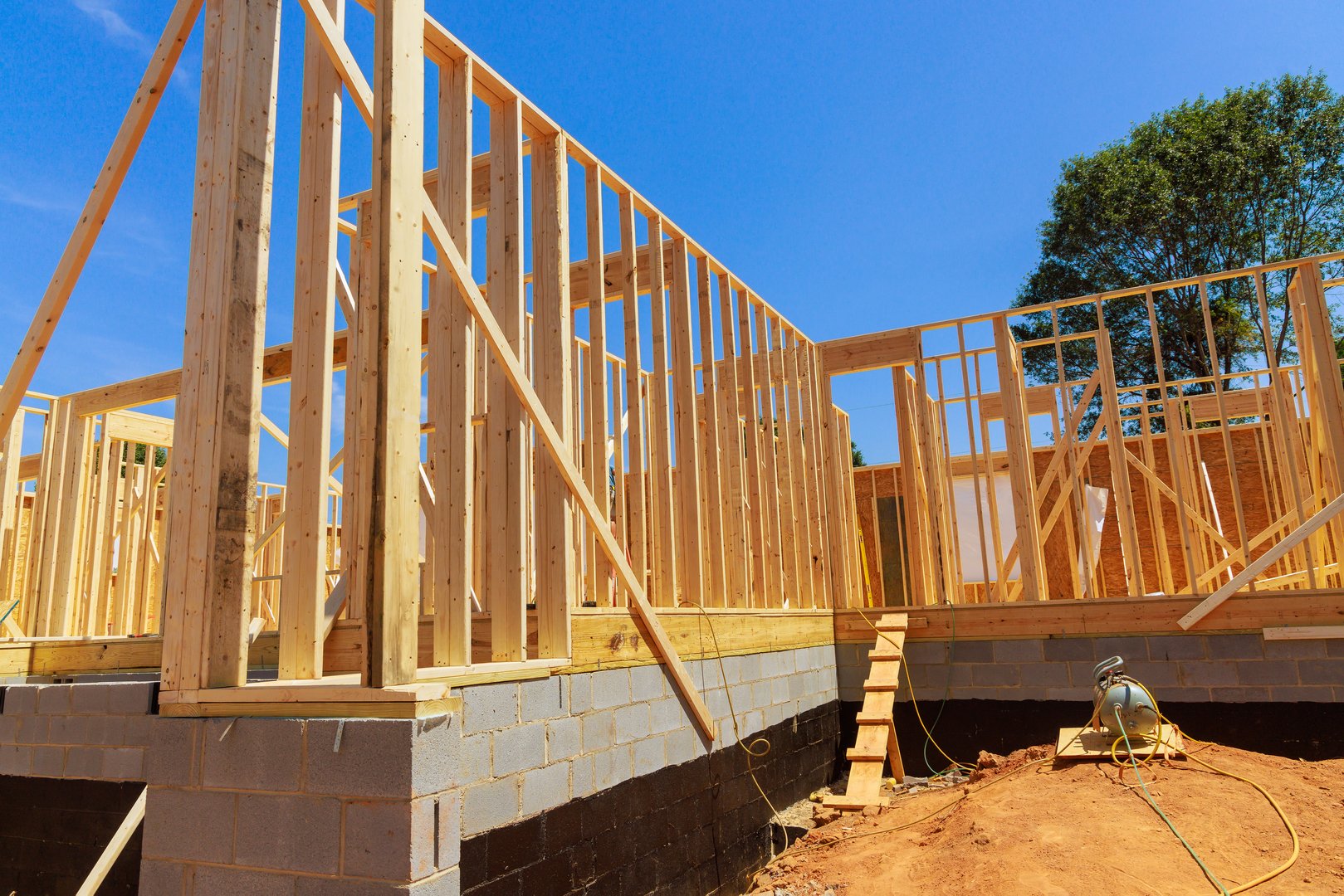 In construction of new house, unfinished interior timber support beams are framed