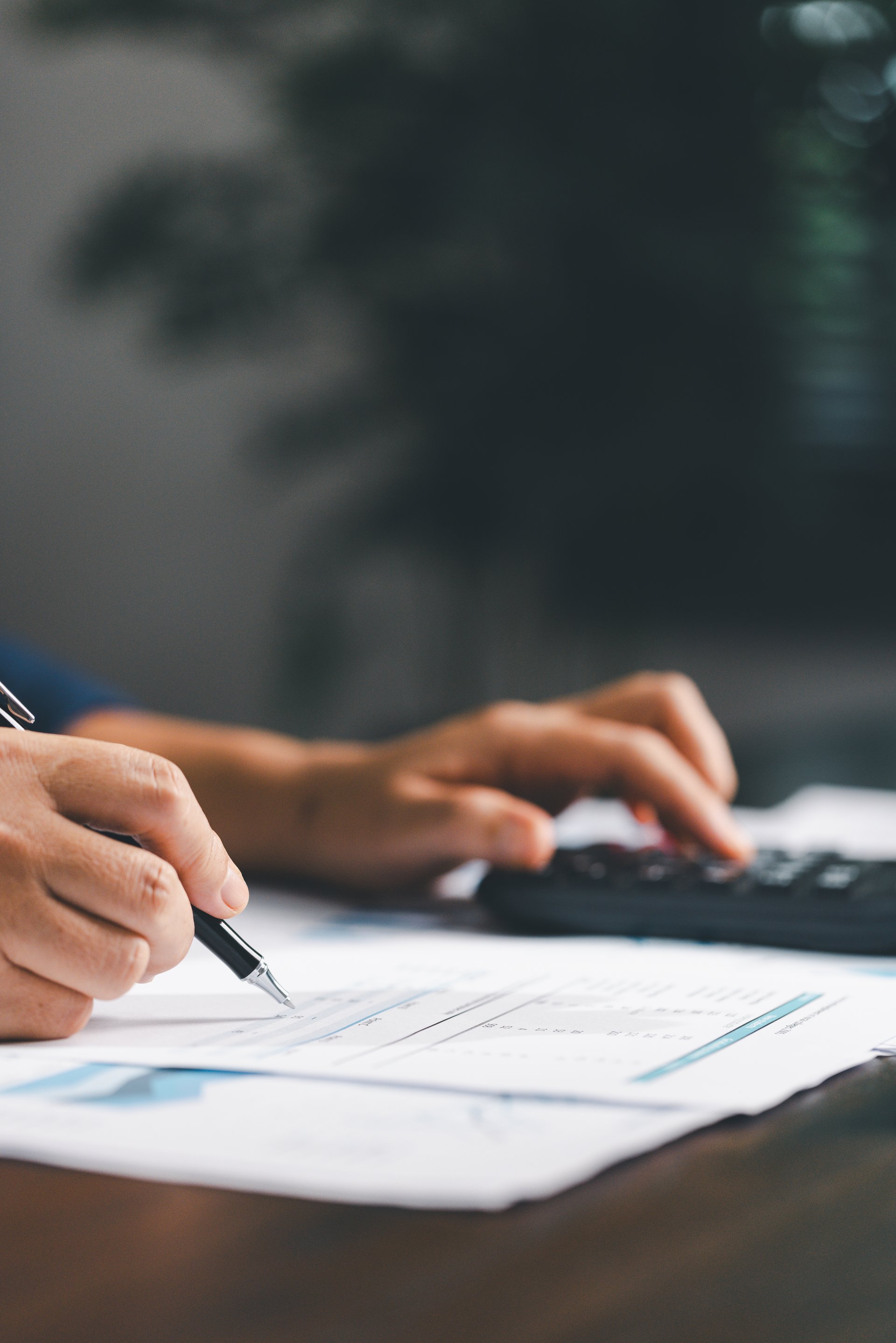 Businesswoman at table, calculator, monthly tax calculations, budgeting, managing expenses-illustrating business, finance, accounting, banking concept essential for effective budget management.