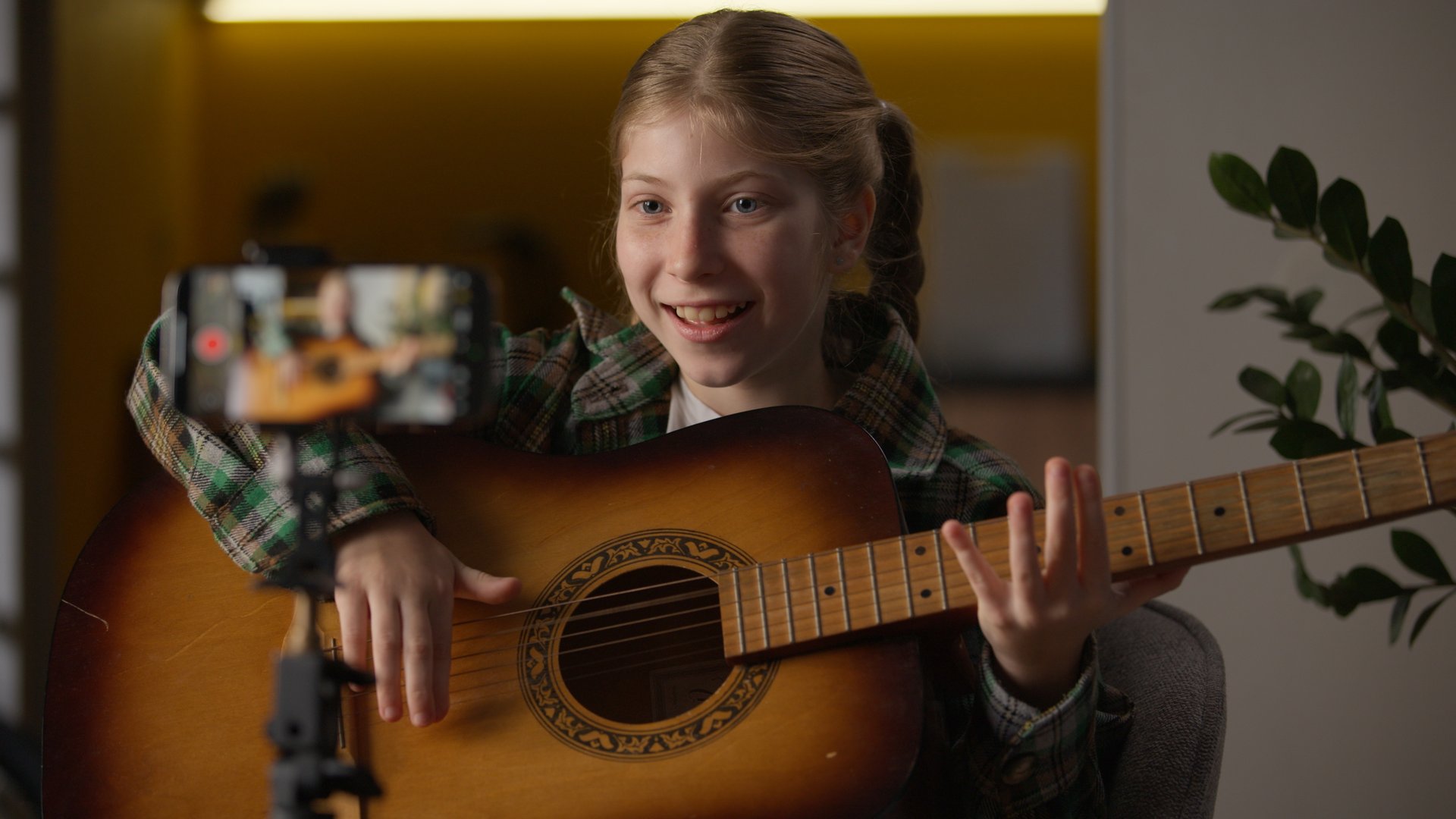 Creative little girl blogger teaching how to play guitar