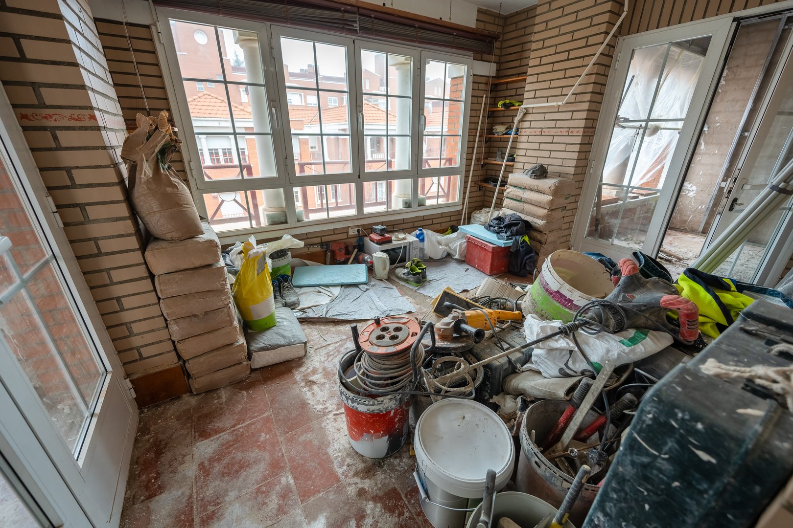 Work area inside a house with lots of materials and tools for renovation