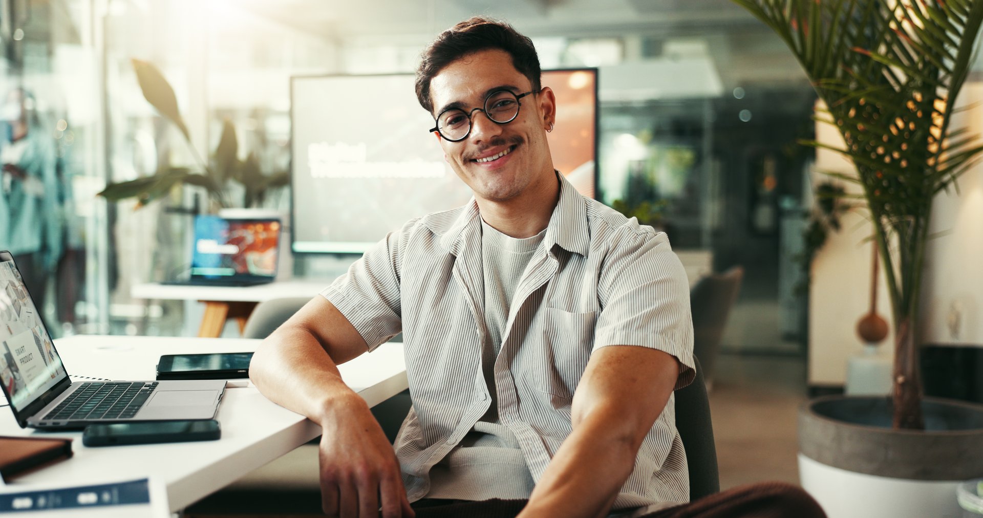 Portrait, creative and happy business man in startup for opportunity, ambition or job growth. Face, glasses and professional entrepreneur, worker and content marketer at social media agency