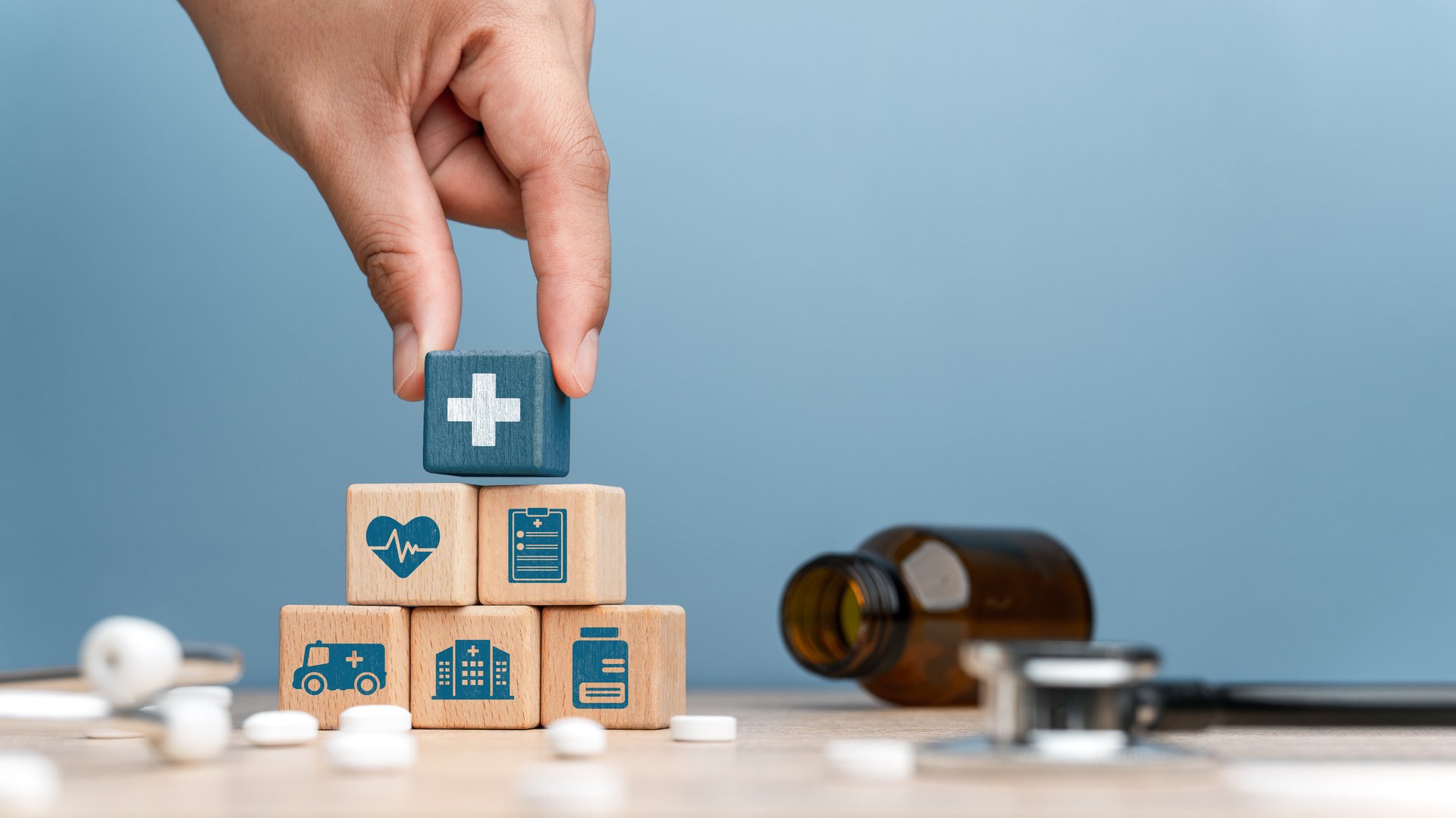 Health care and Health insurance concept. Benefits of health insurance, medical expenses, providing financial security. hand arranging wood block, health insurance icon  on wood block.