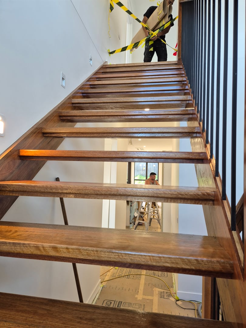 Professional stairs staining and finishing project showing completed work