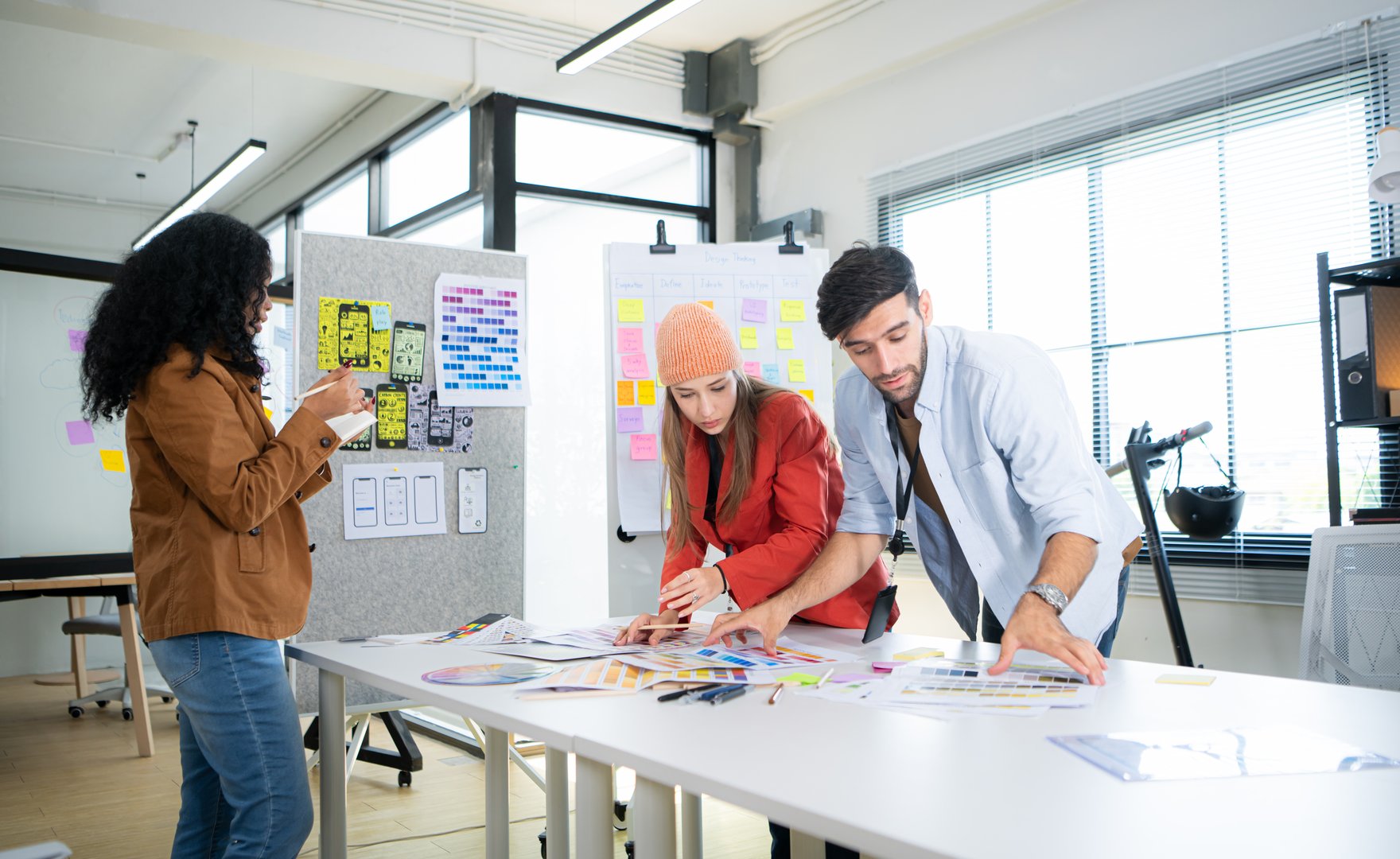 Multiethnic young business people working together in modern office, Collaborate to designing an application for use on the internet network.