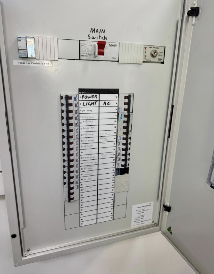 Sparks explosion between electrical cables, on blue background, fire hazard concept, soft focus