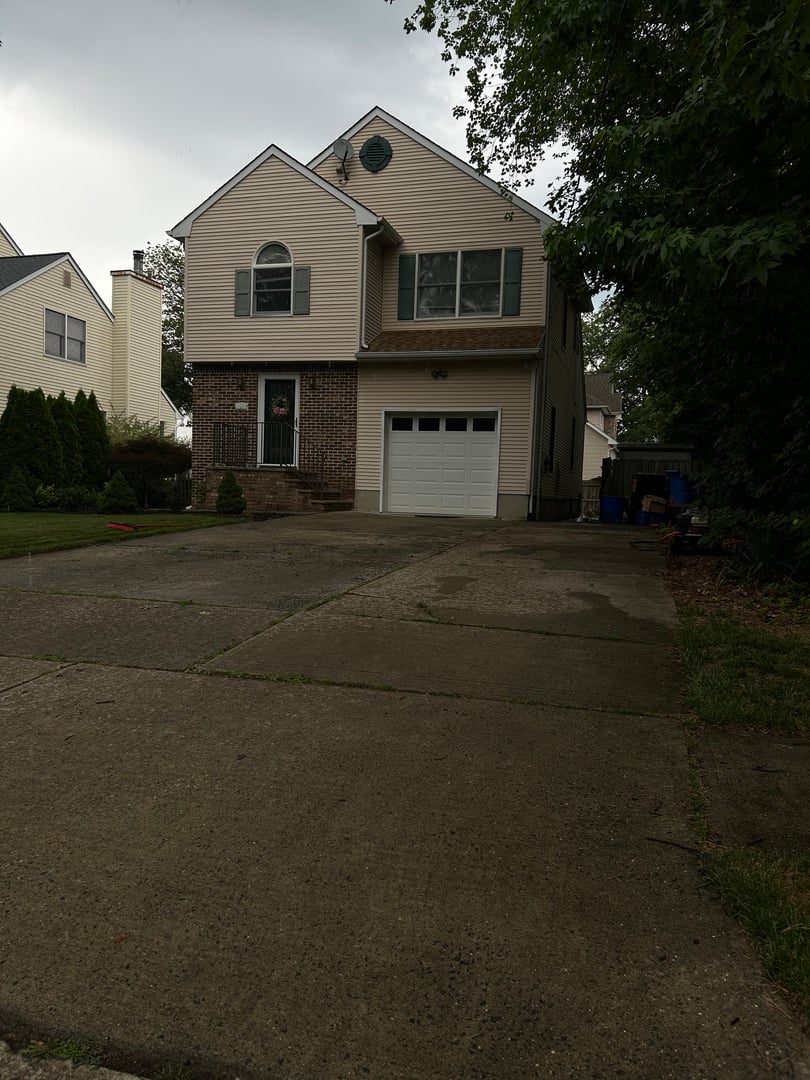 Professional pressure washing equipment in action on residential property