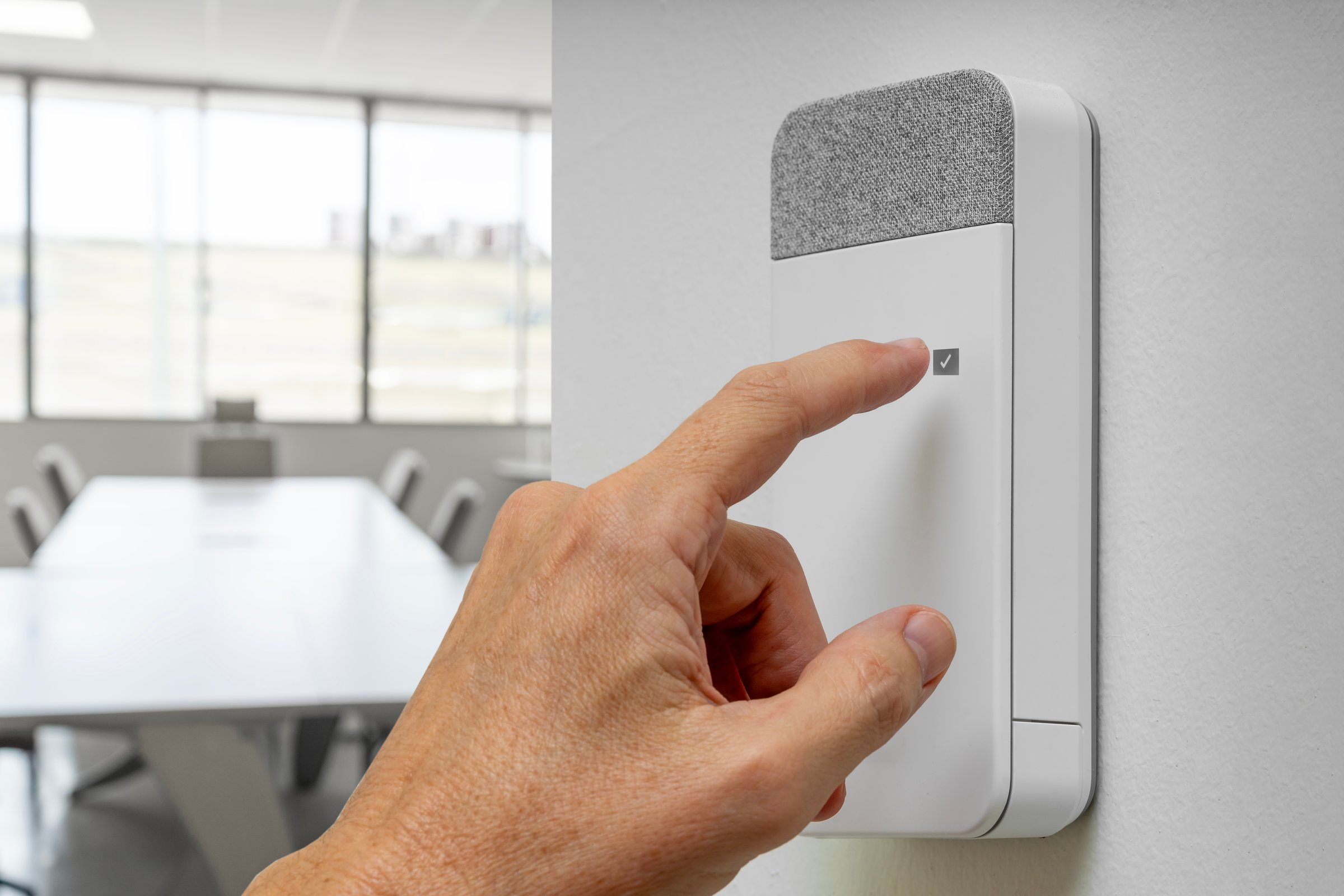 Close-up of a male hand activating a burglar alarm on the control panel. Security for companies, offices, coworkings, businesses and buildings.