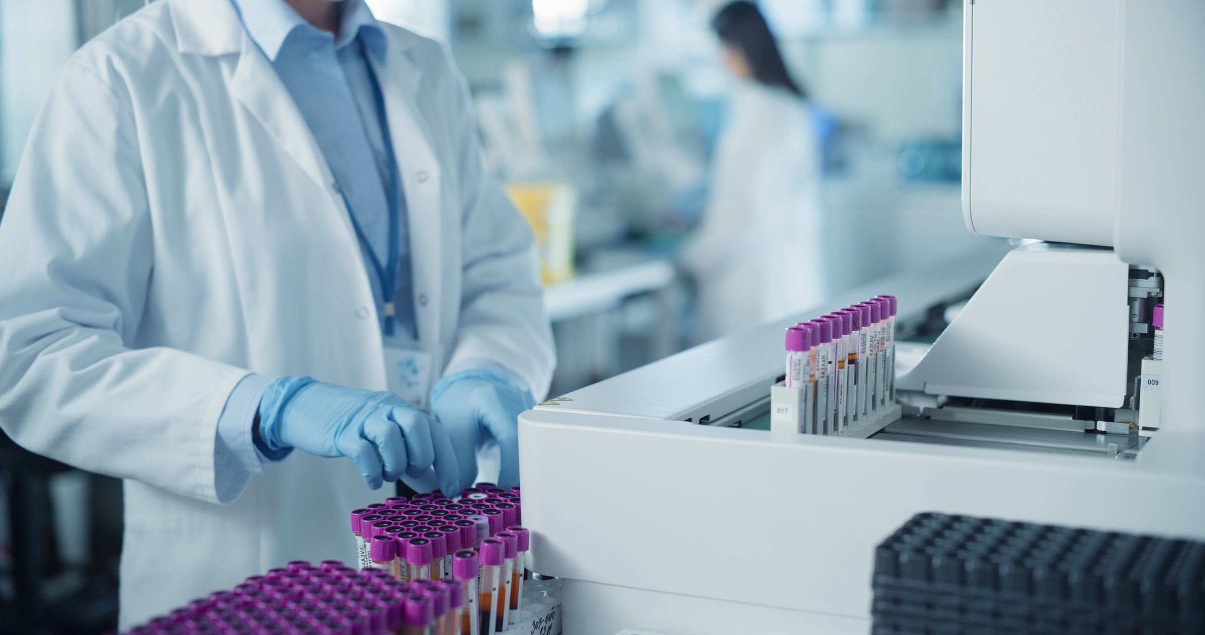 Close Up on Anonymous Female Scientist Working in a Sterile Environment in Modern Healthcare Facility. Skilled Laboratory Technician Operating Advanced Diagnostic Equipment, Processing Blood Samples
