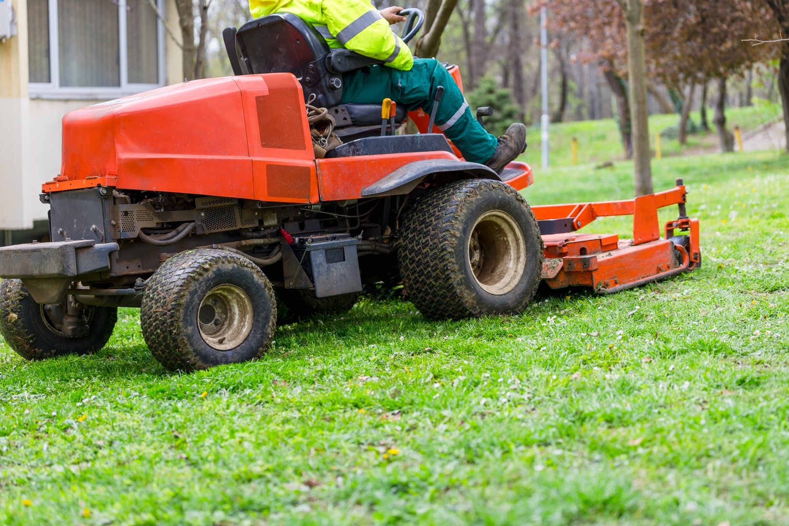 Professional lawn mower trimming lush green grass