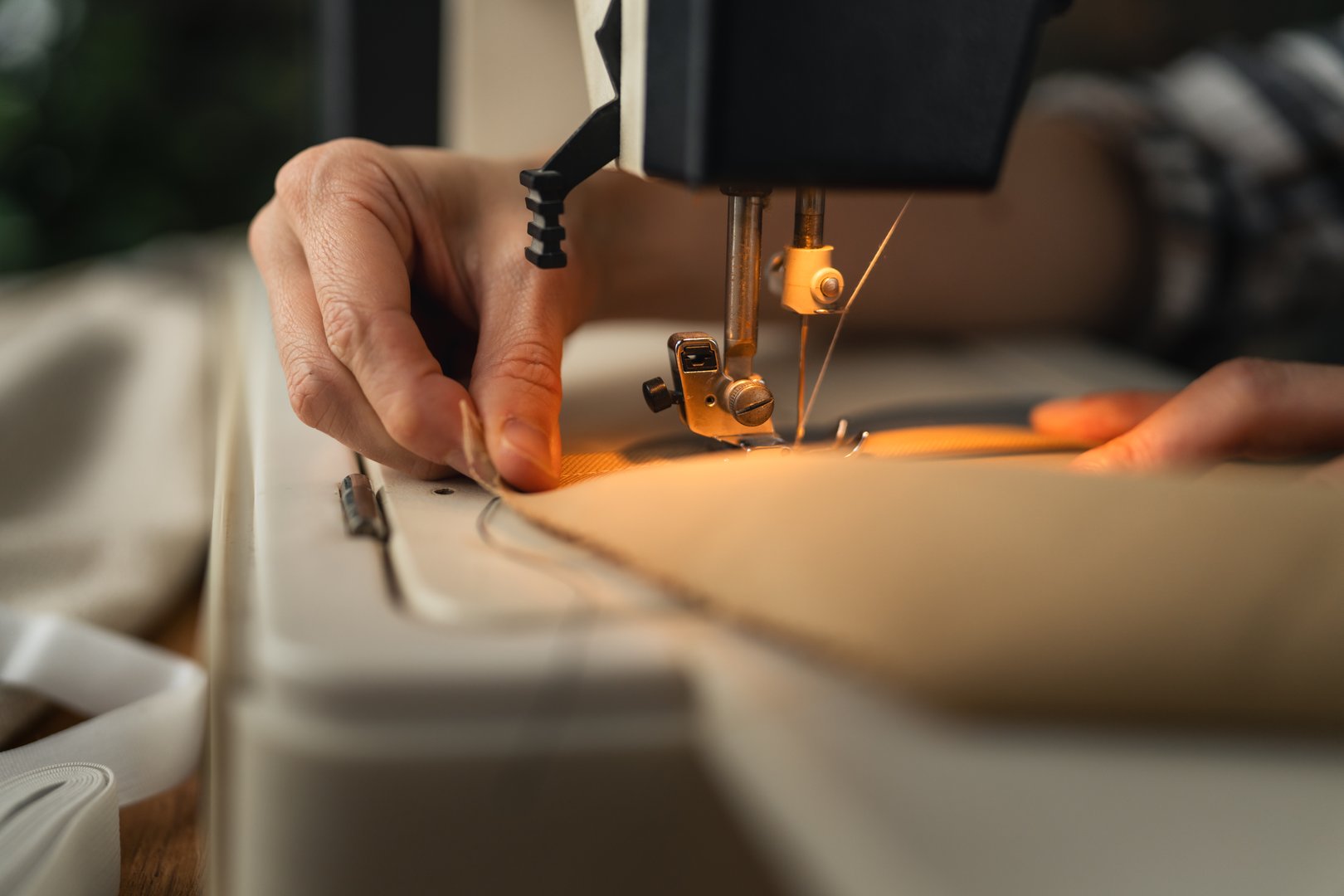 Tailor working on fabric with sewing machine