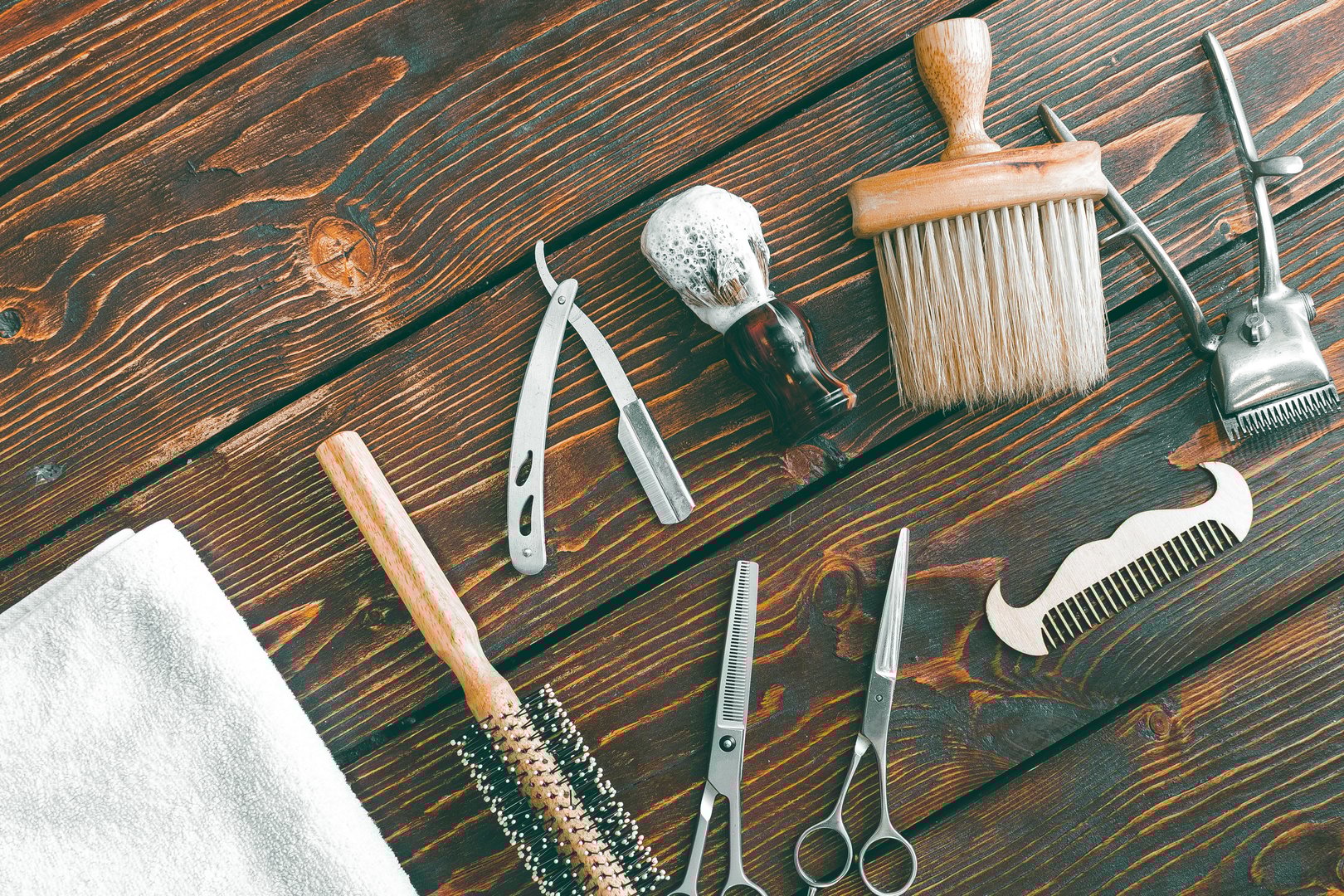 Barbershop accessories on wooden table. Barbershop background copy space.