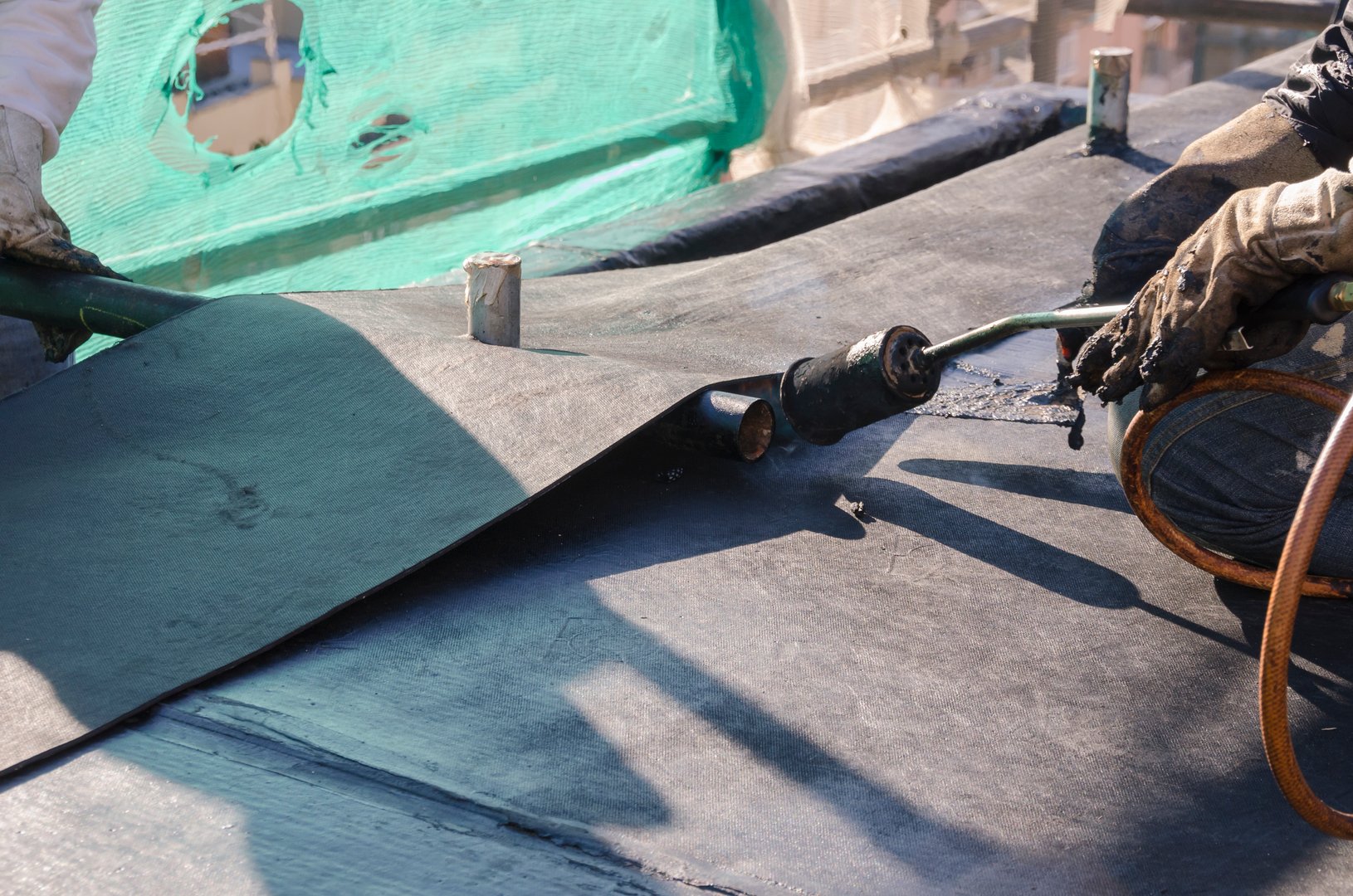 construction work during the renovation of a roof of a building with bituminous sheath