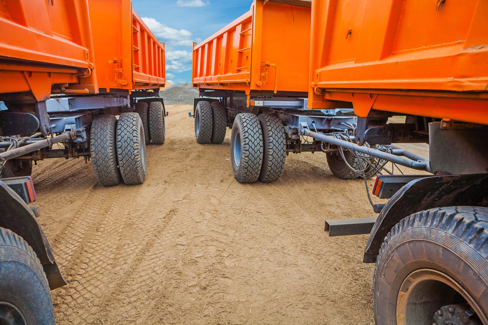 Side tipper trucks at mining site loading minerals