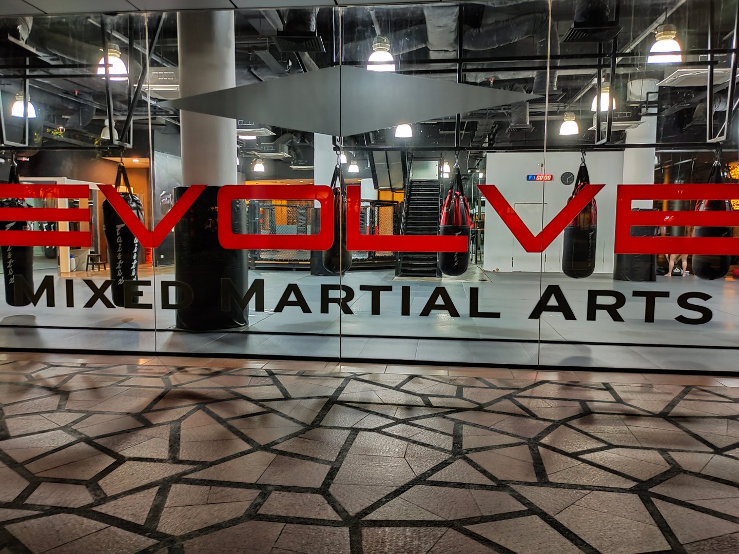 Singapore - January 21, 2025: Empty modern fight club with punching bags of different shapes for practicing Evolve Mixed Martial Arts at Singapore