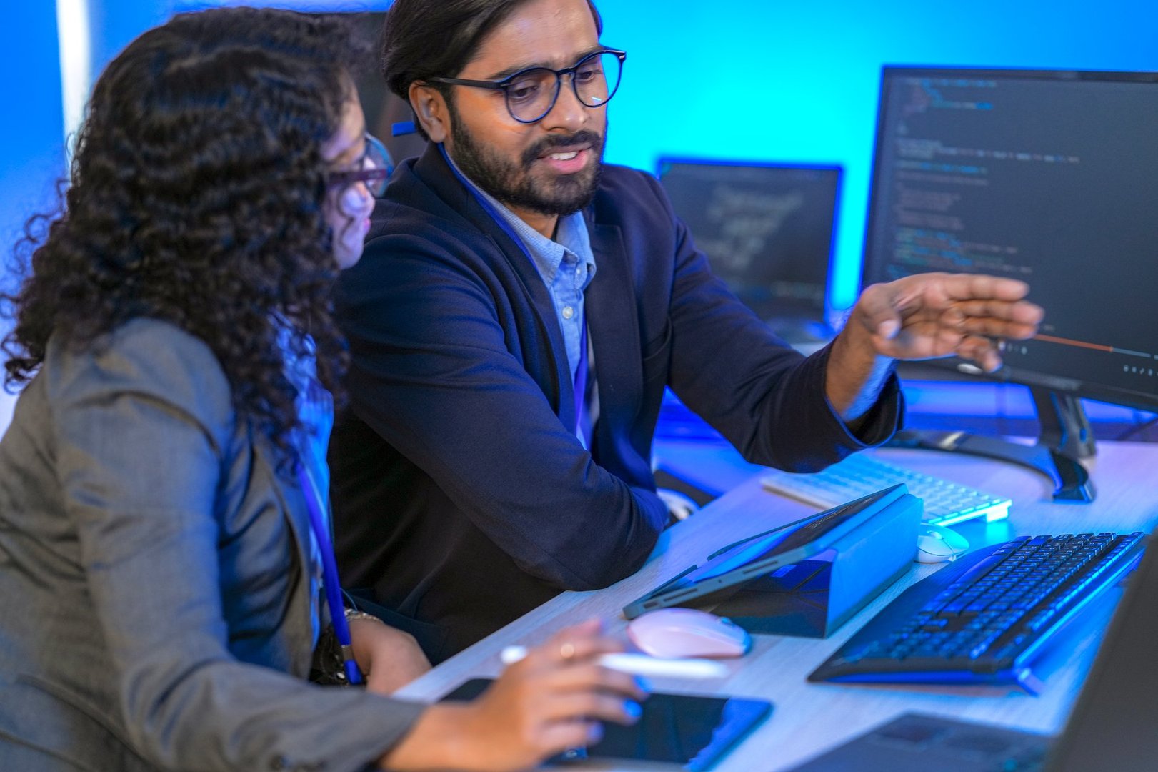 A dedicated IT team collaborates in a command center, working on a critical software deployment or incident response. Concept for system implementation, teamwork, and operations.