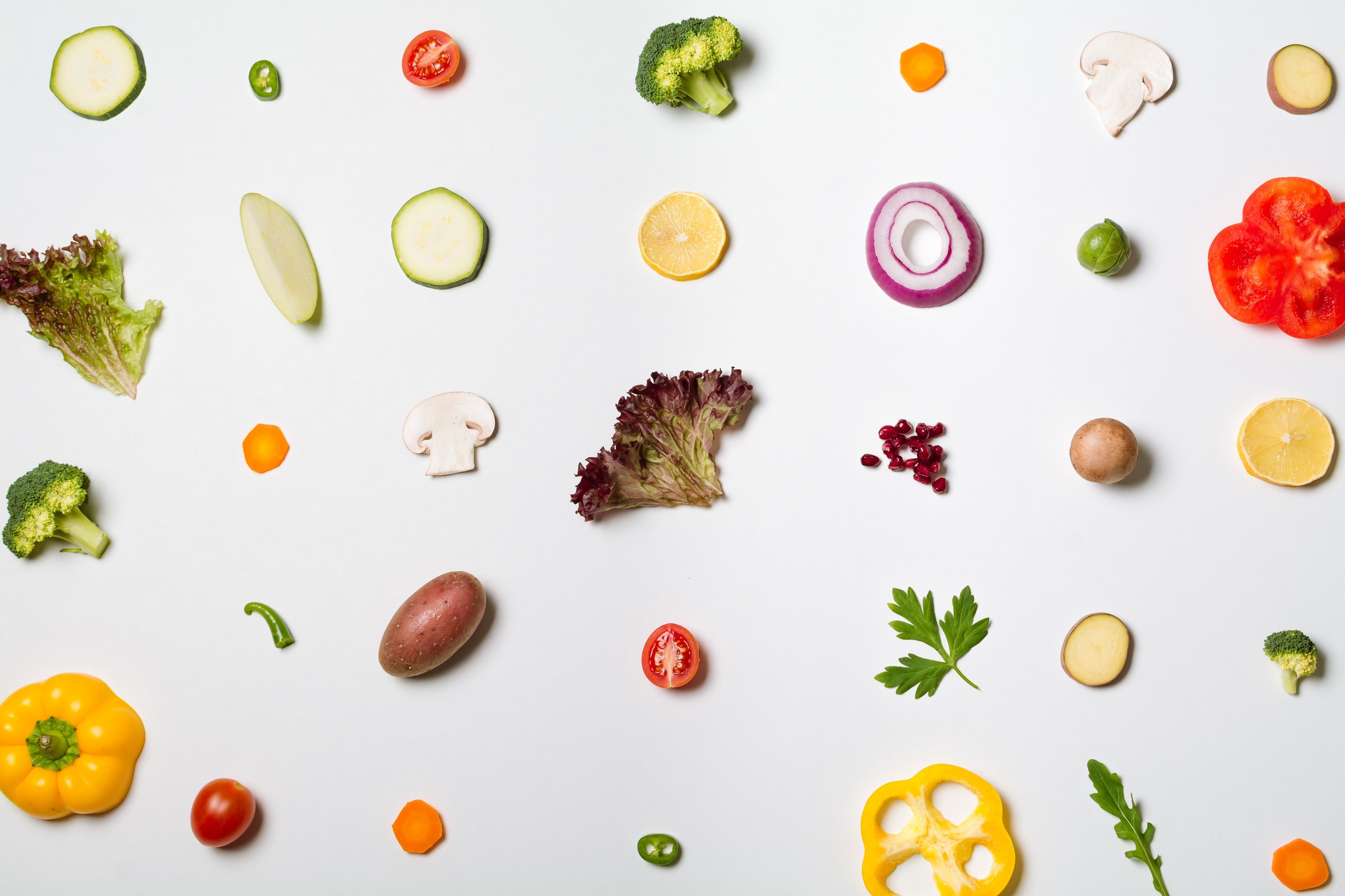Deconstructed salad ingredients on white background