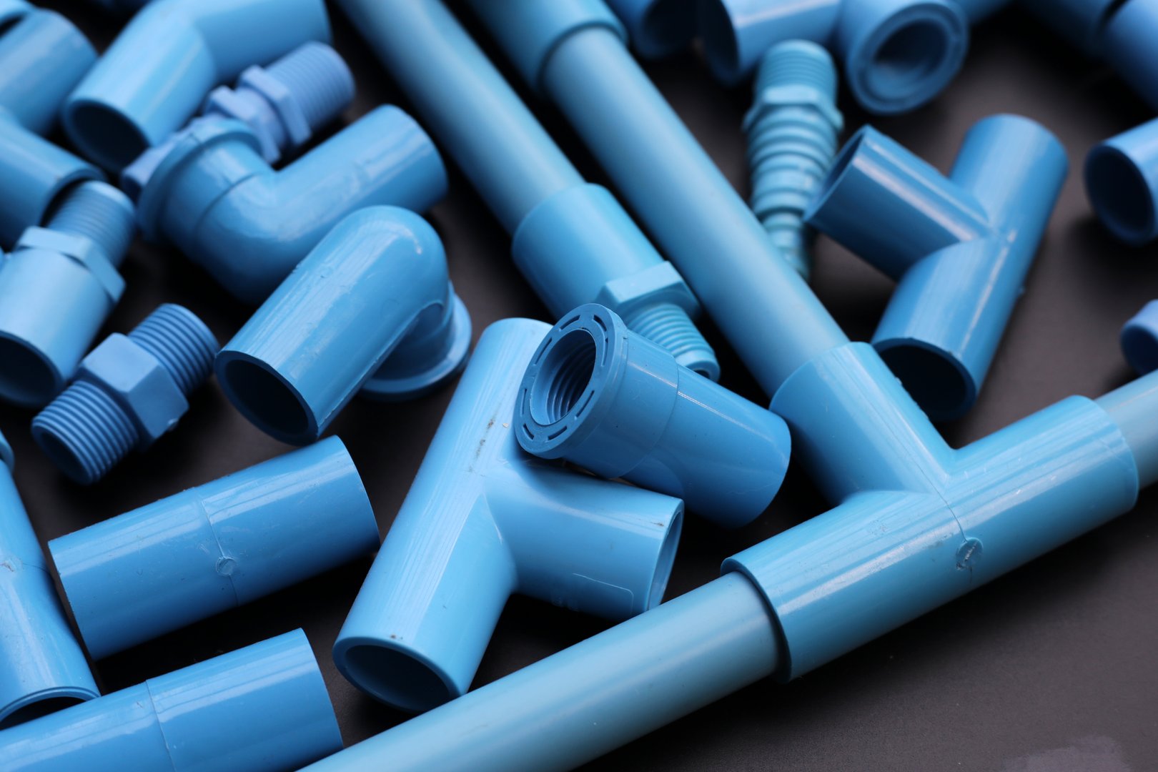 Plumber equipment with blue pvc pipe connections for plumbing work.