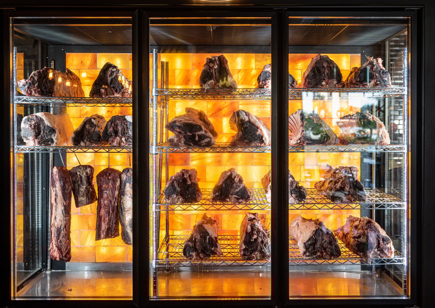 Beef hung and lined up in a dry aged beef cabinet