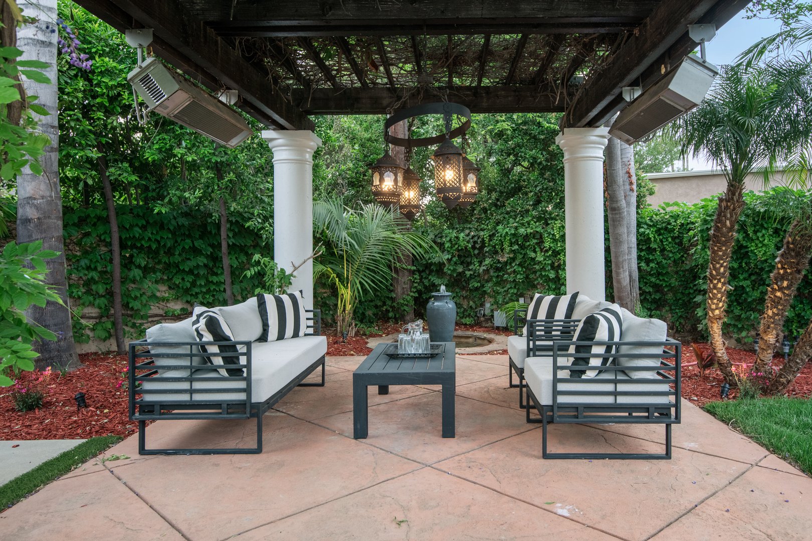 An outdoor seating area with sofas and a coffee table in a modern new construction home in Los Angeles