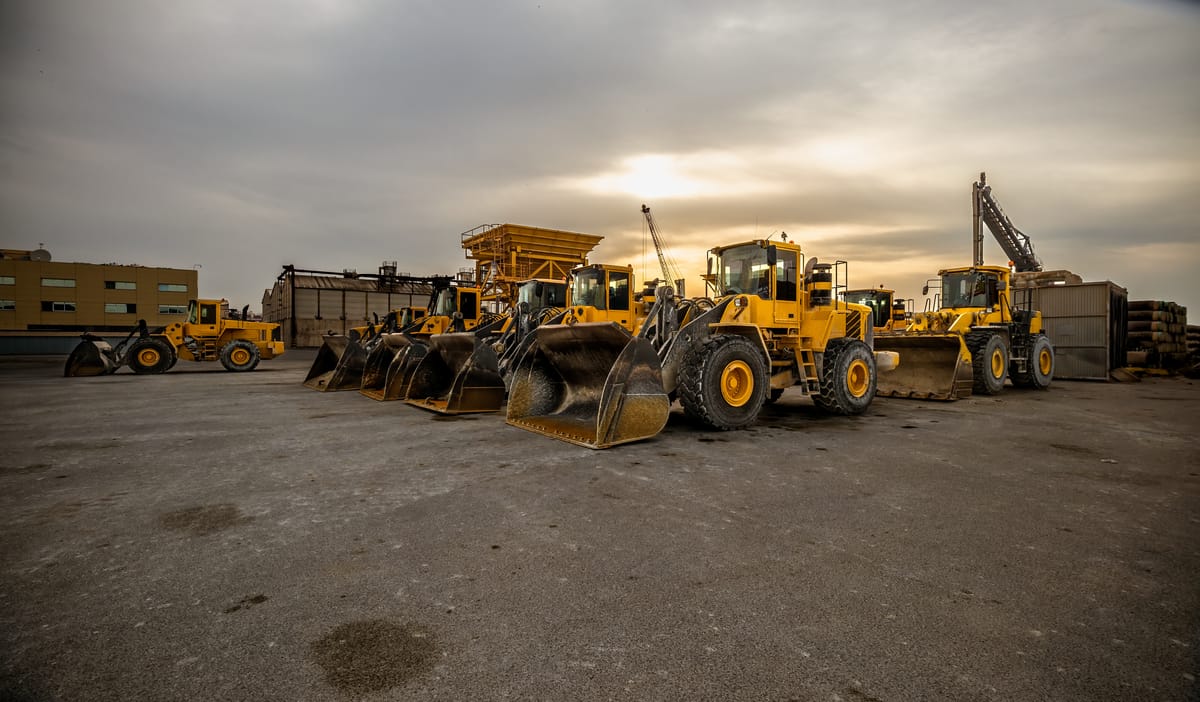yellow wheel loader or bulldozer in formation. Earthmoving and aggregates. Construction work.