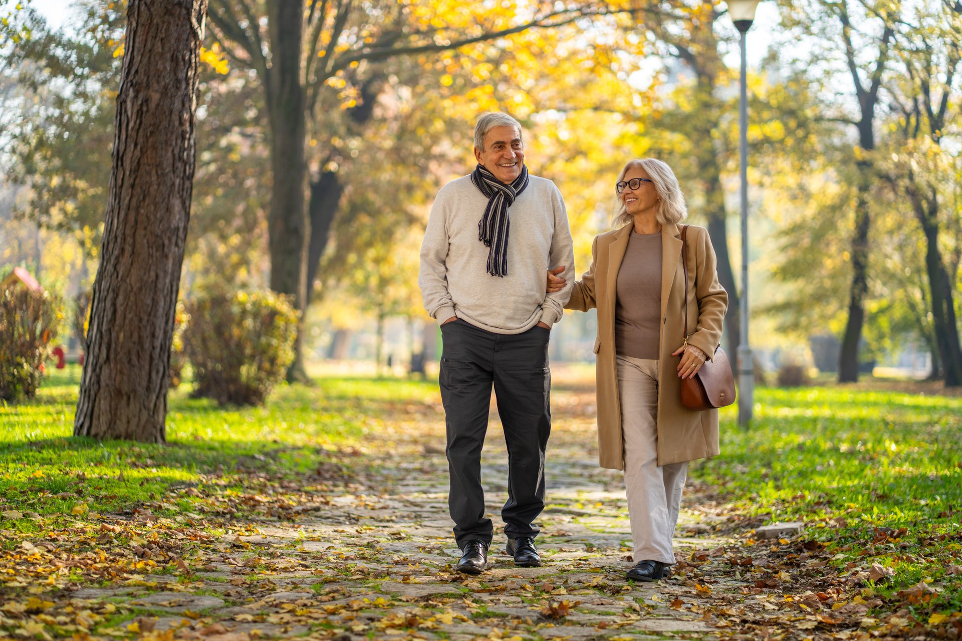 Mature adult couple walking together in a park