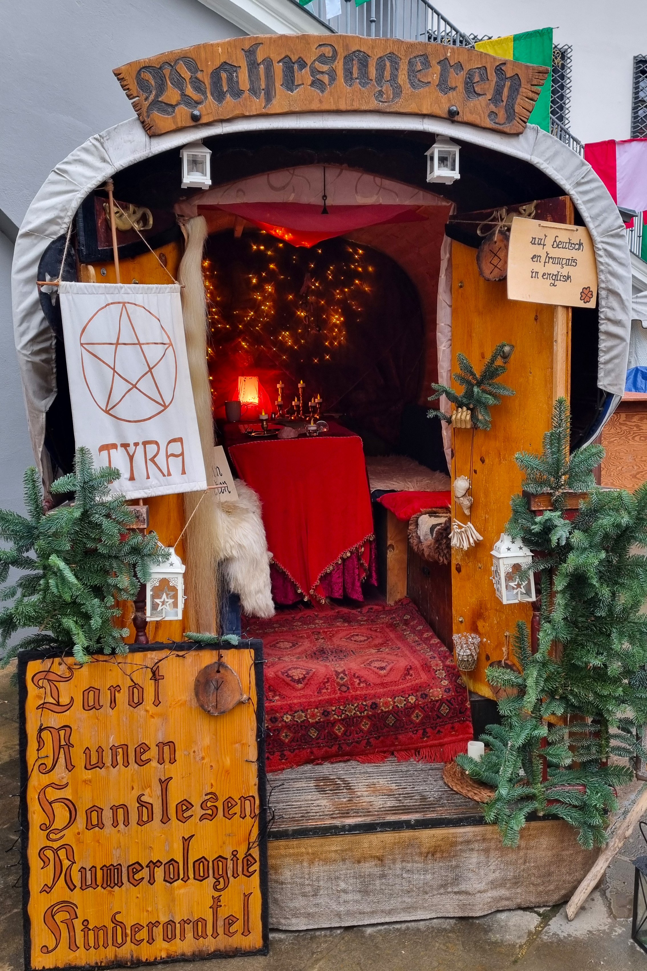 Dresden, Germany, December 8, 2024: A cozy fortune teller's caravan adorned with mystical elements like tarot cards, runes, and numerology signs. the interior, warmly lit by candles, creates an inviting atmosphere for spiritual readings and exploration.