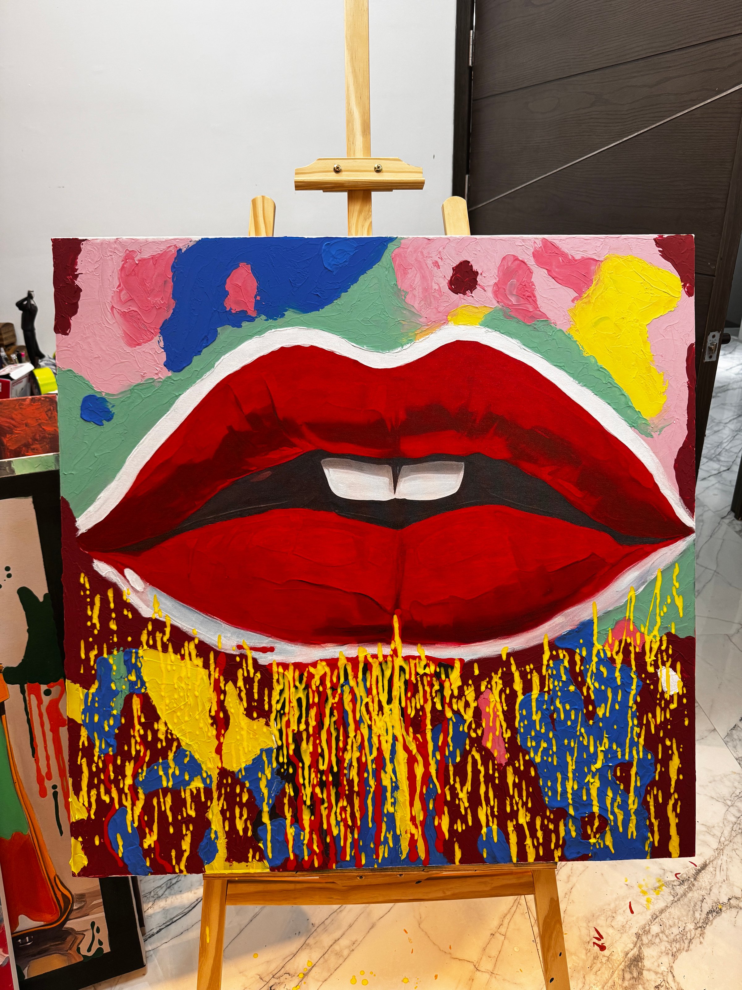 A mosaic artwork of a golden face on a dark background, with intricate detail and a shiny, reflective surface.
