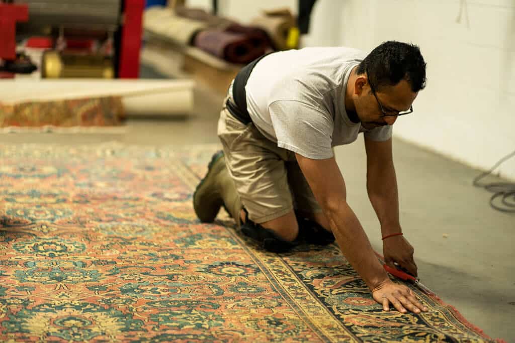 Expert rug inspection and assessment for antique rug repair - identifying damage and restoration needs