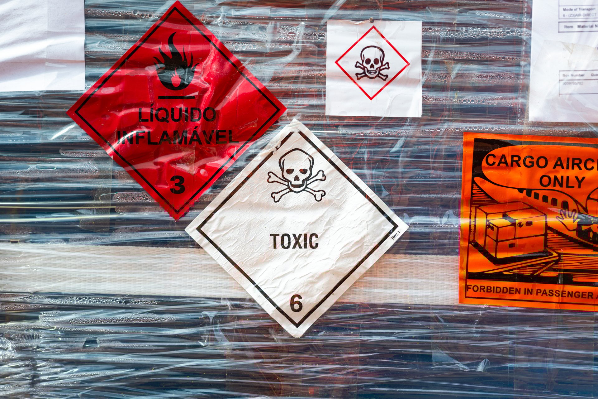 Toxic chemical with skull icon and flammable liquid sticker placard that installed on the hazard chemical goods package that prepare for logistic. Industrial safety sign, close-up with selective focus