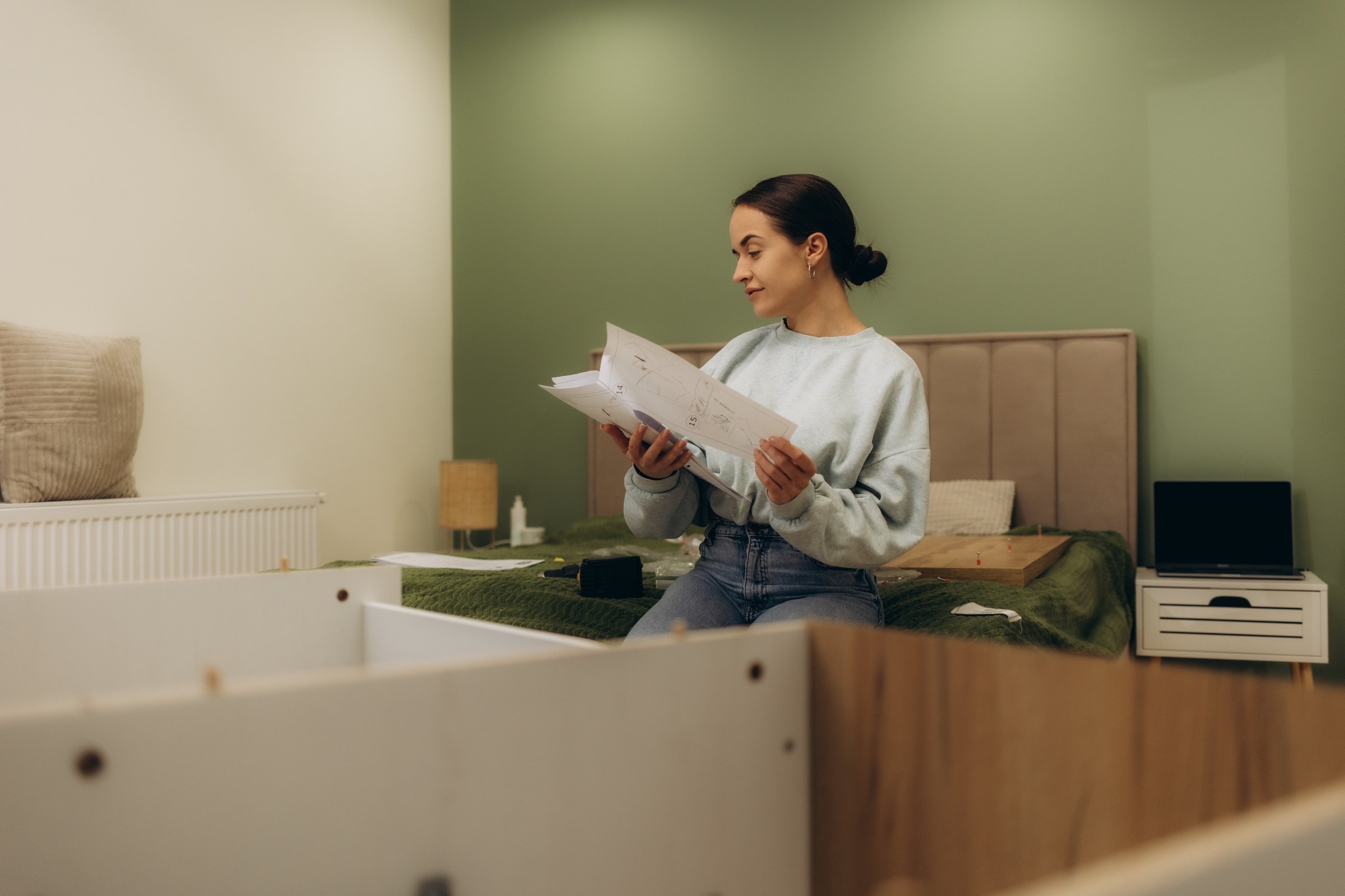 Woman assembling furniture at home