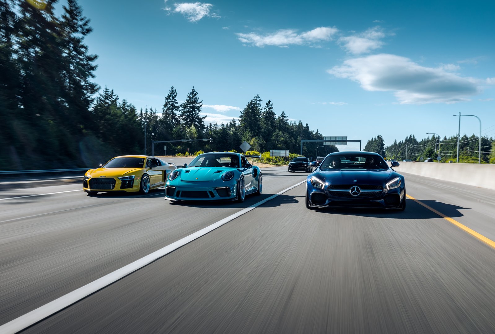 German luxury cars on coastal highway