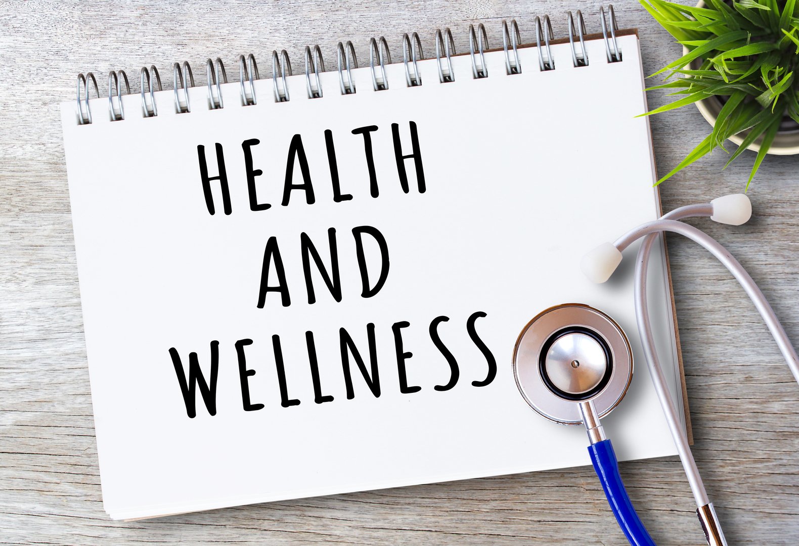 Business quotes, HEALTH AND WELLNESS on notebooks or paper in office desk, office workplace