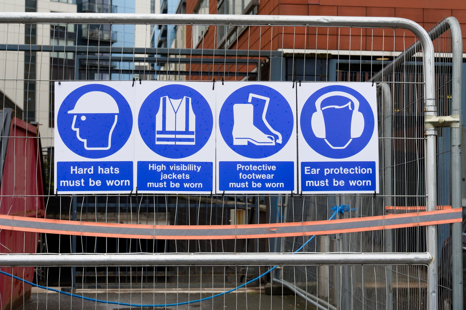 Construction site health and safety sign on fence UK