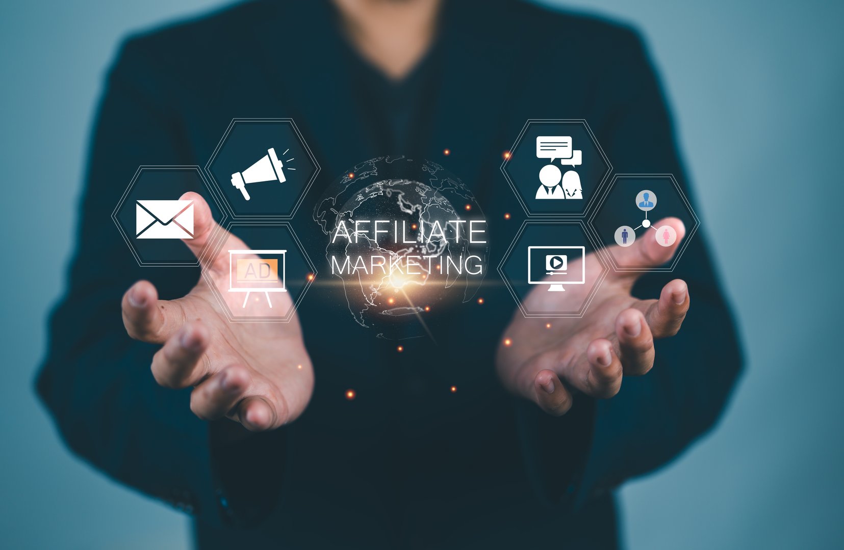 Affiliate marketing. Marketing strategies to advertise products and services. Businessman holding globe with affiliate marketing icons on virtual screen for new business concept.