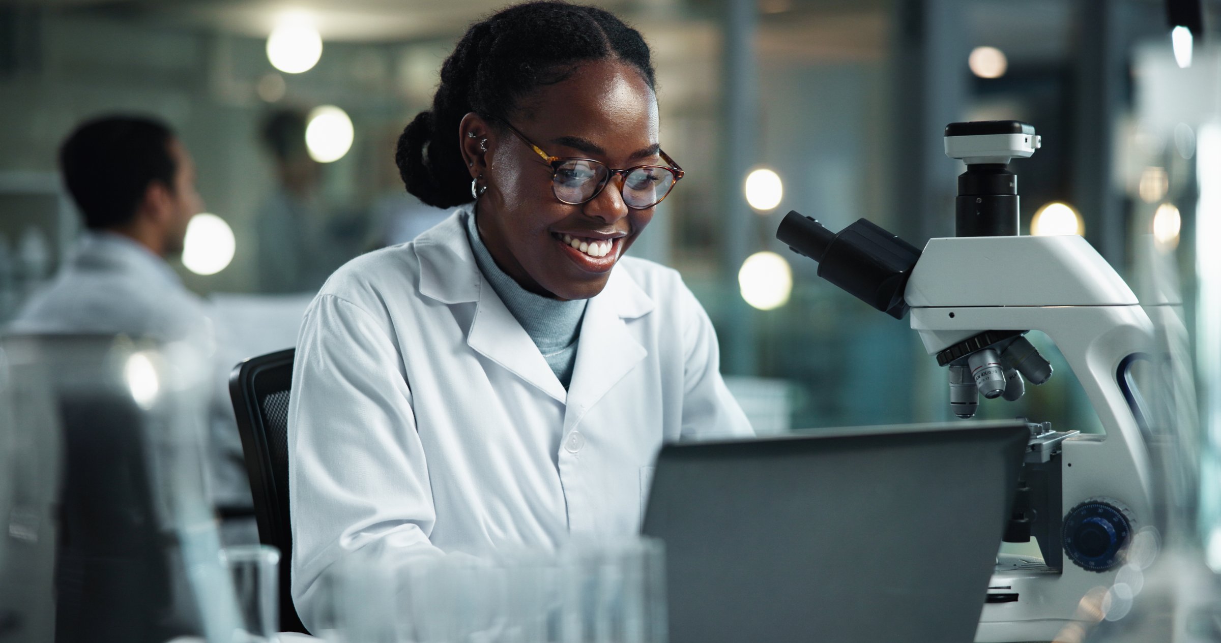 Woman, laptop and scientist in lab for innovation, research and study on genetic analysis. Female person, biology investigation and internet for experiment update, check science and night for plan